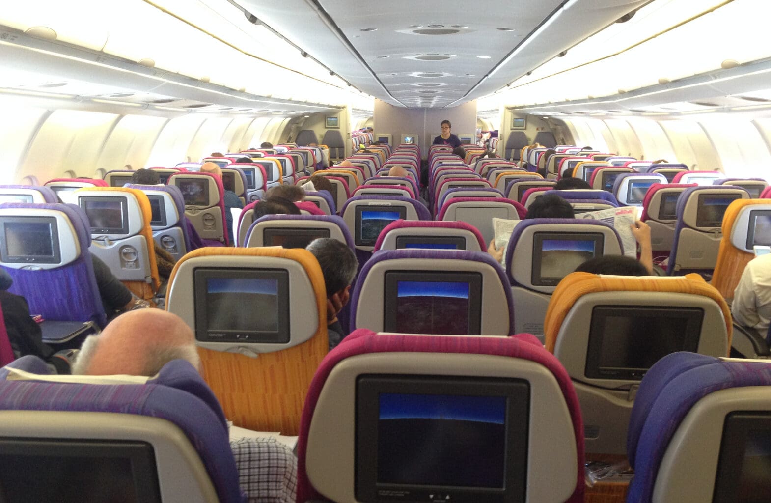 a group of people sitting in an airplane