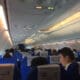 people sitting in an airplane with signs on them