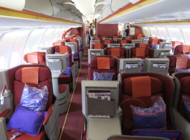 a plane with seats and a person standing in the back