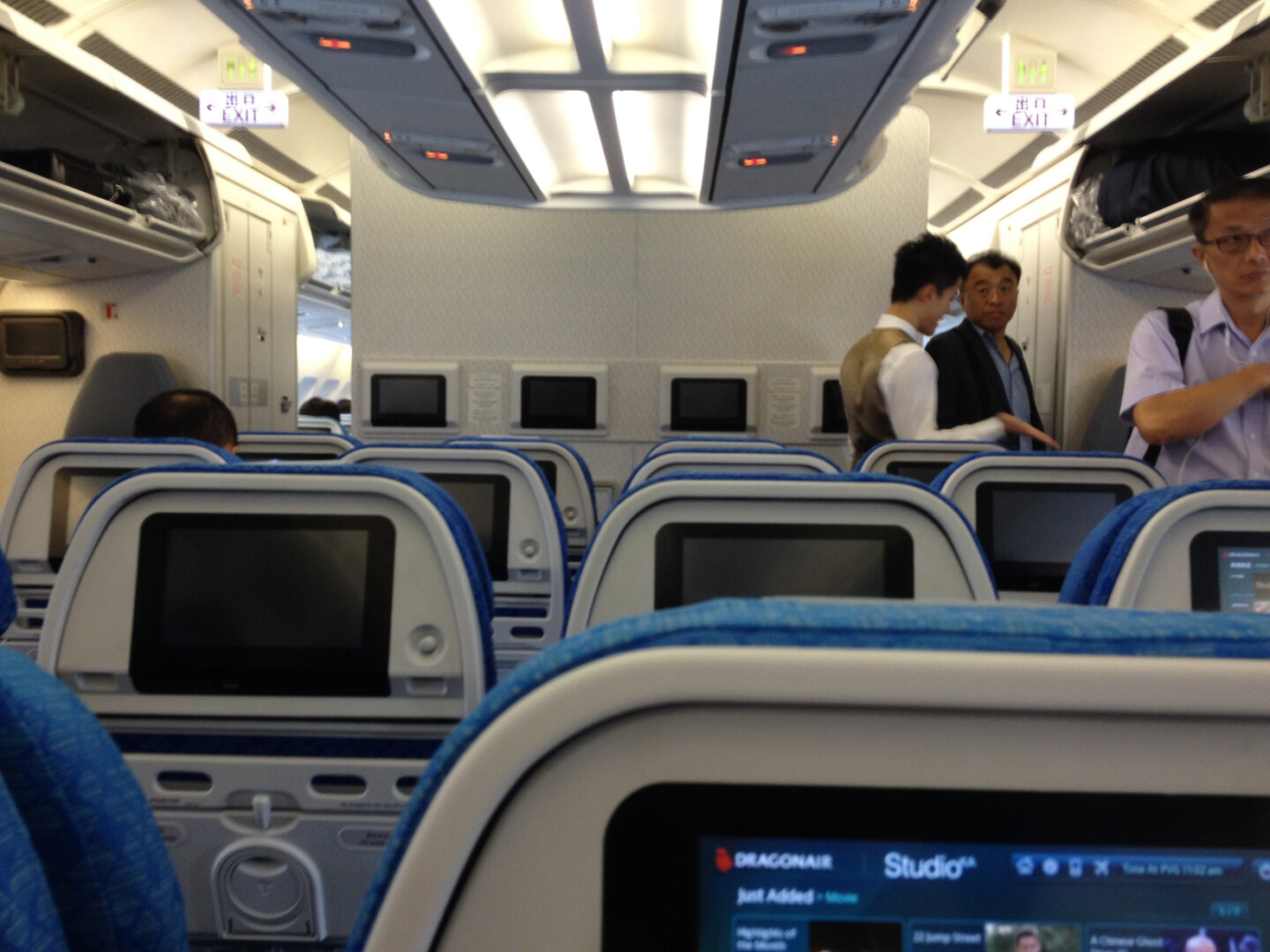 a group of men standing in an airplane