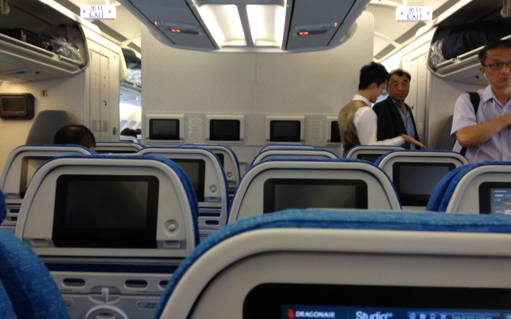 a group of men standing in an airplane