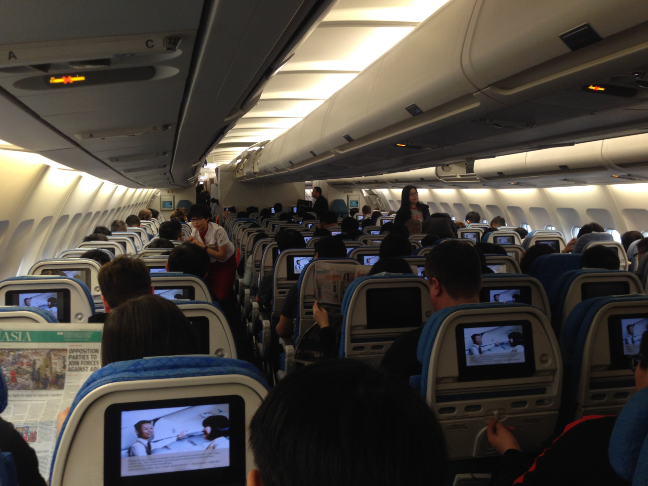 a group of people sitting in an airplane