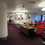 a room with red chairs and tables