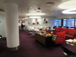 a room with red chairs and tables