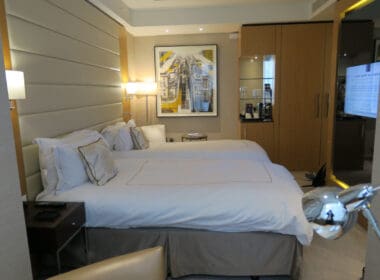 a bedroom with two beds and a picture on the wall