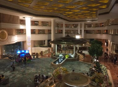 a large building with a fountain and people in it