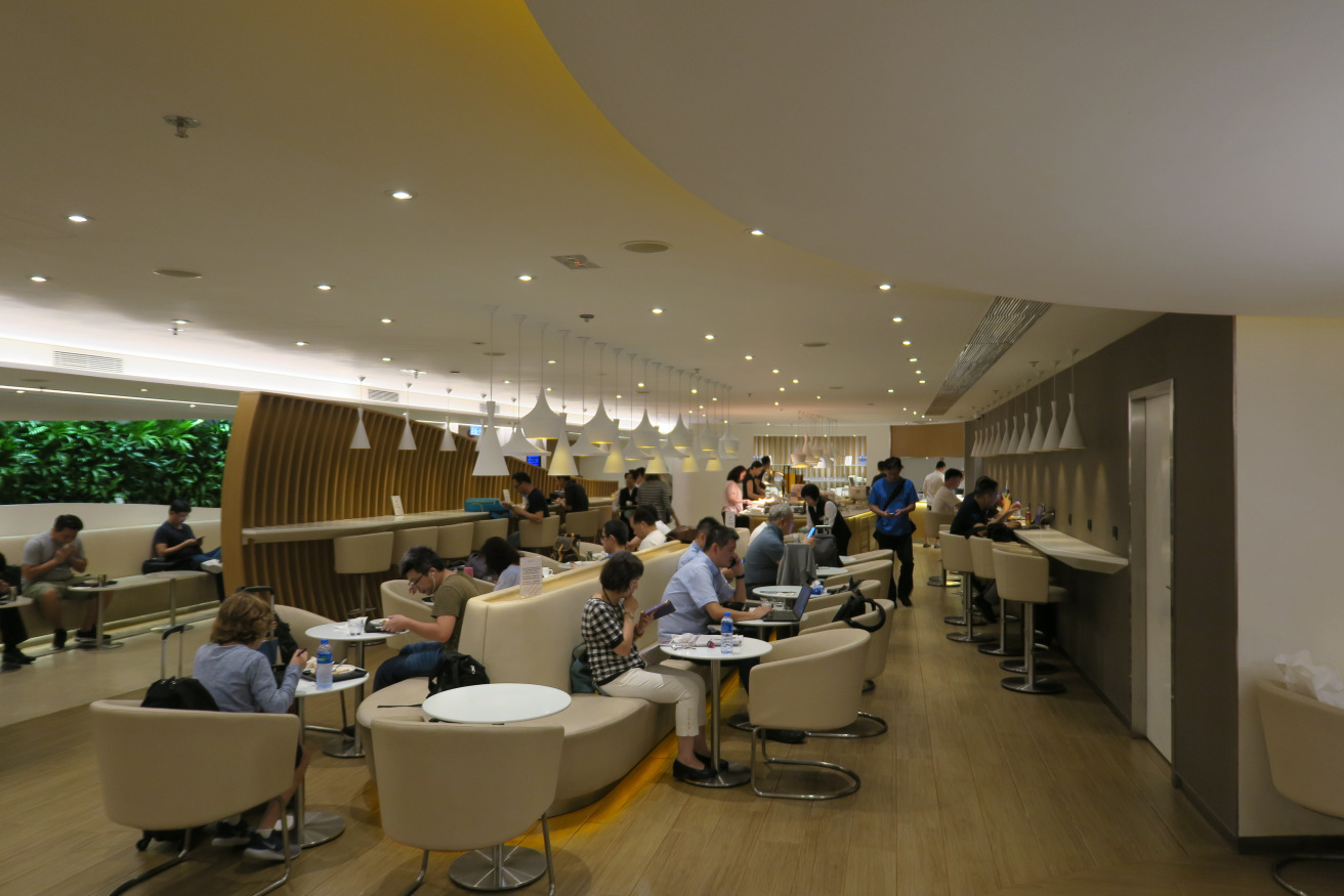 a group of people sitting at tables in a room with lights