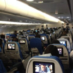 a group of people sitting in an airplane