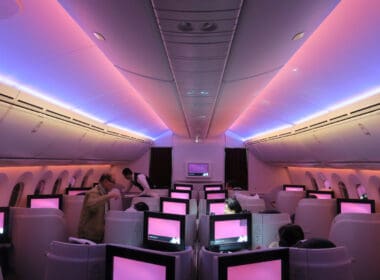 people in an airplane with many monitors