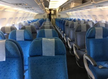 a row of blue seats on an airplane