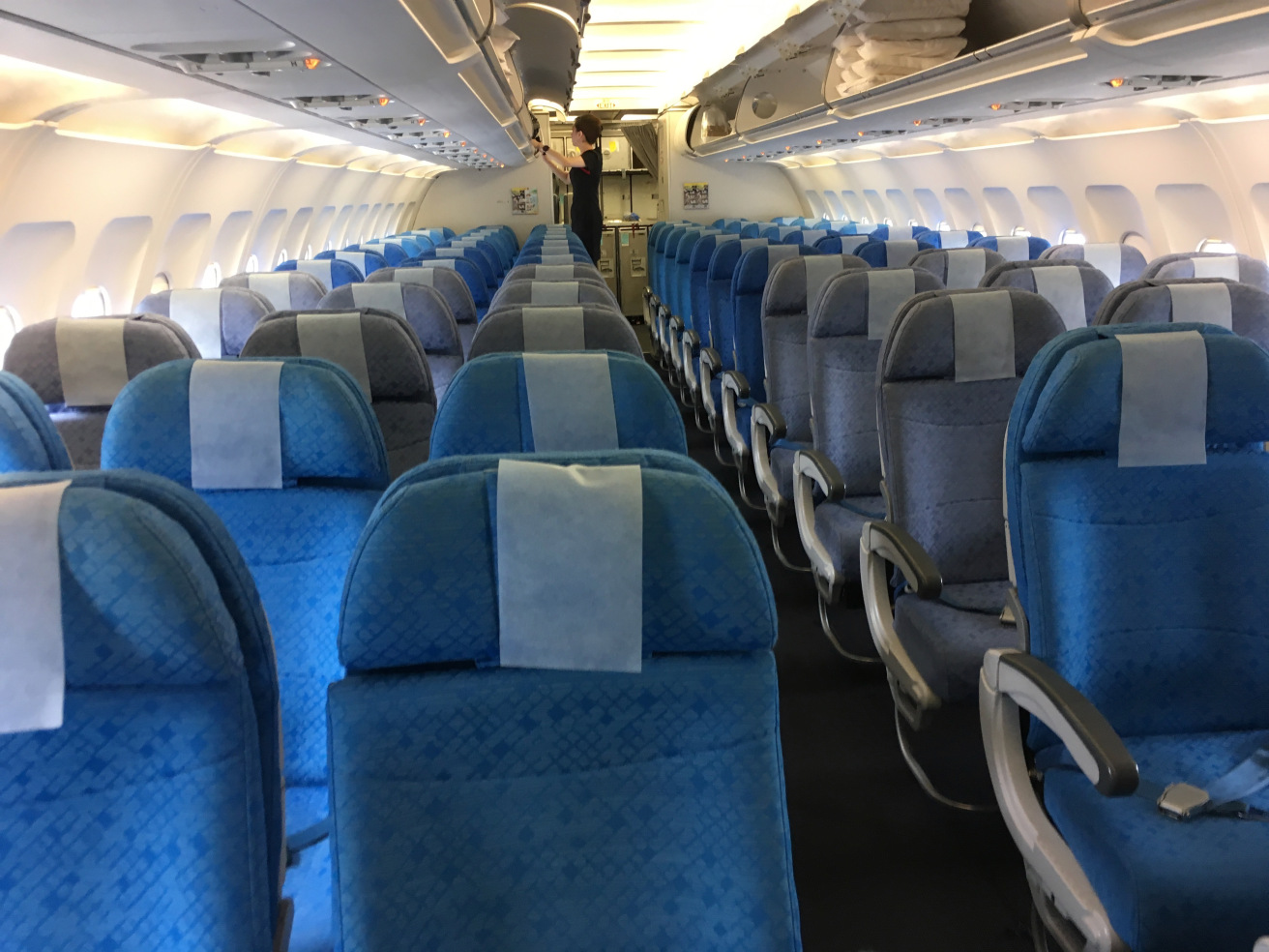 a row of blue seats on an airplane