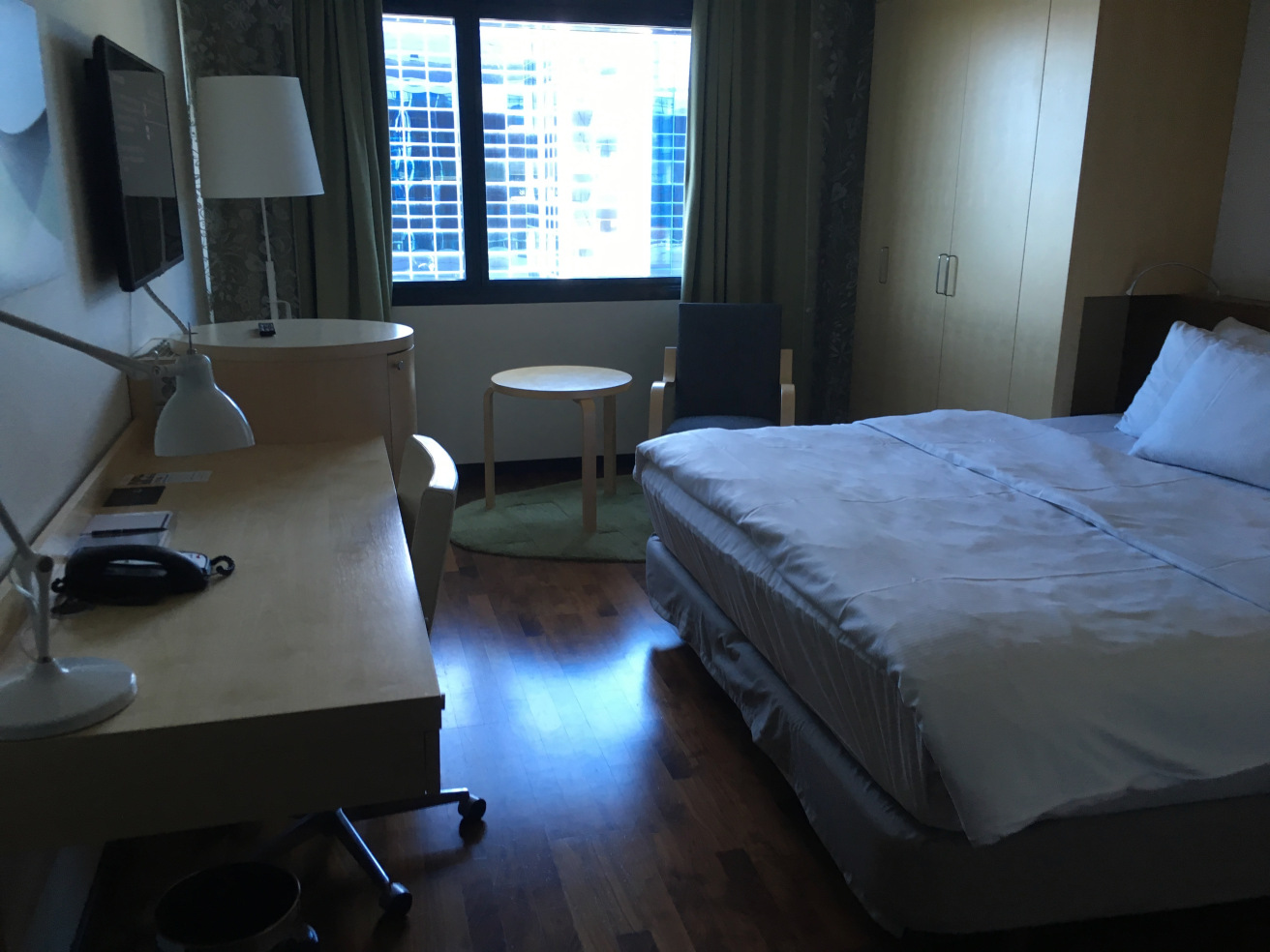 a room with a bed and a desk and a chair