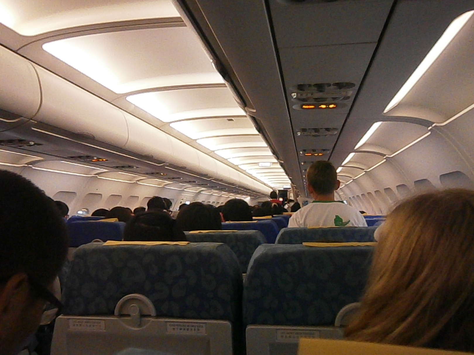 a group of people sitting in an airplane