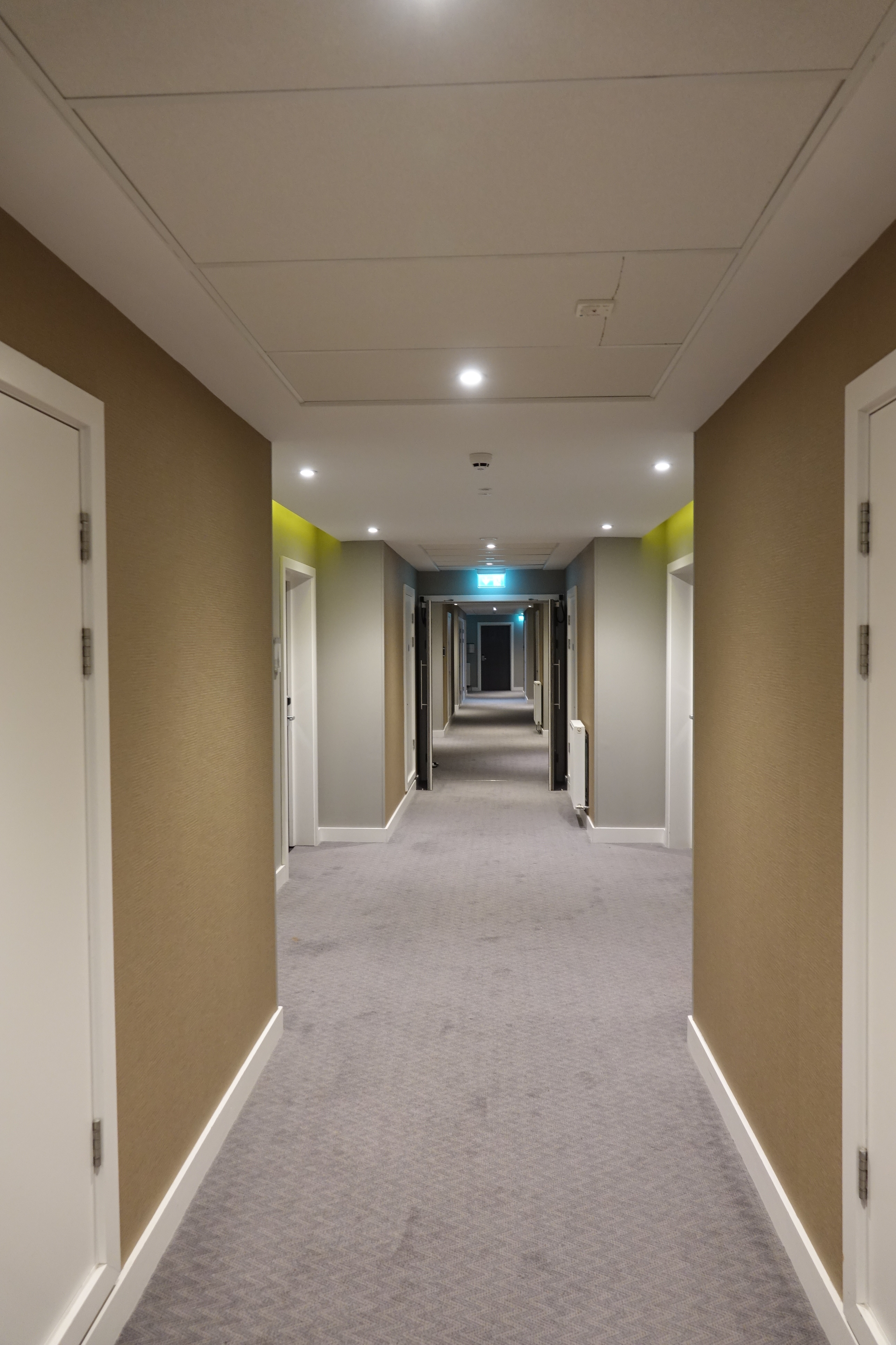 a hallway with doors and lights