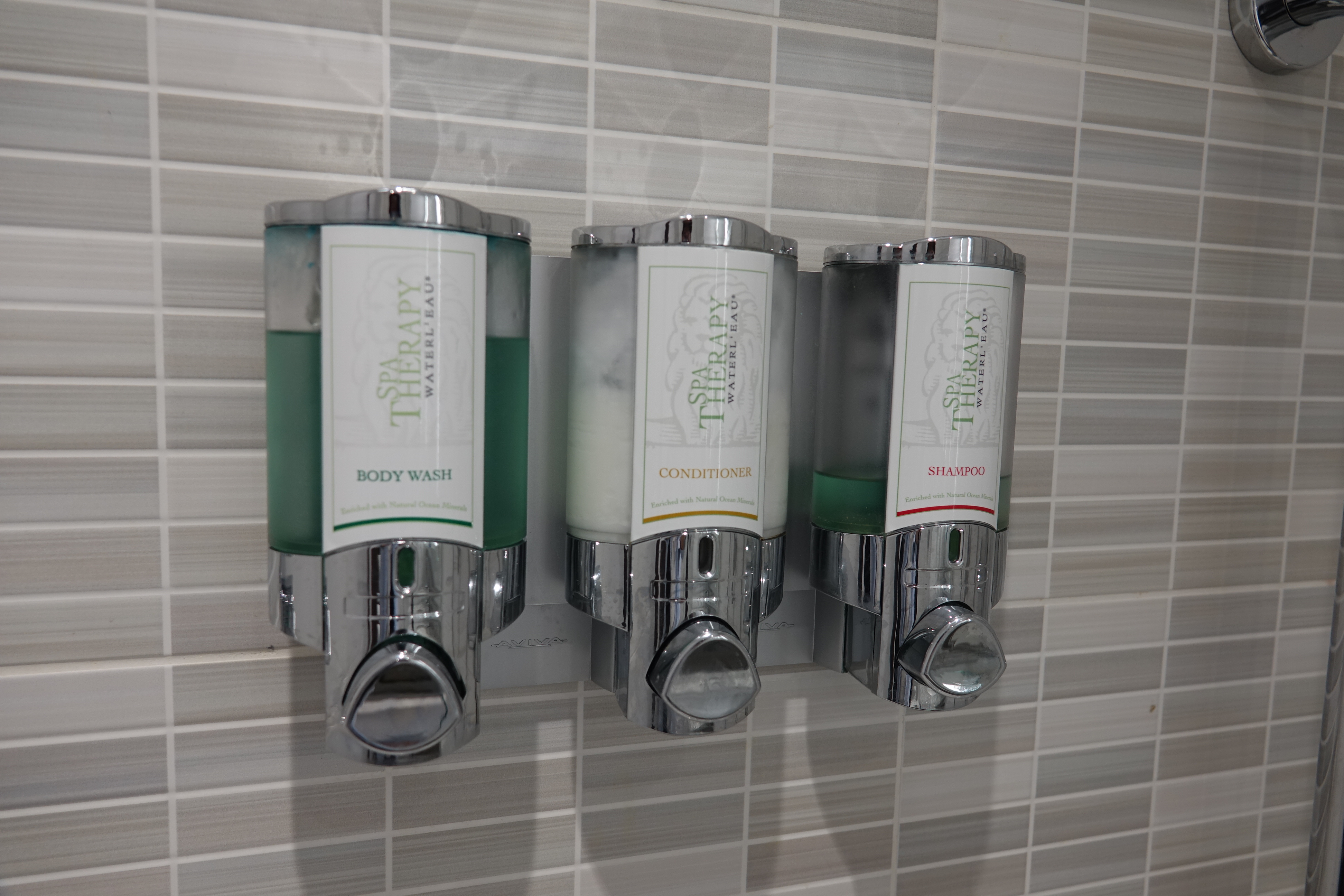 a group of soap dispensers on a wall