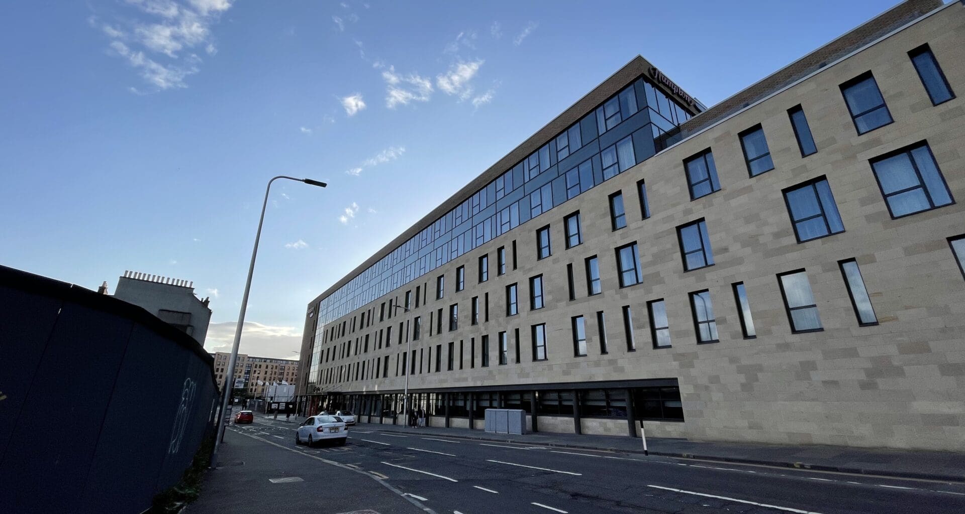 a street with a building and cars on it