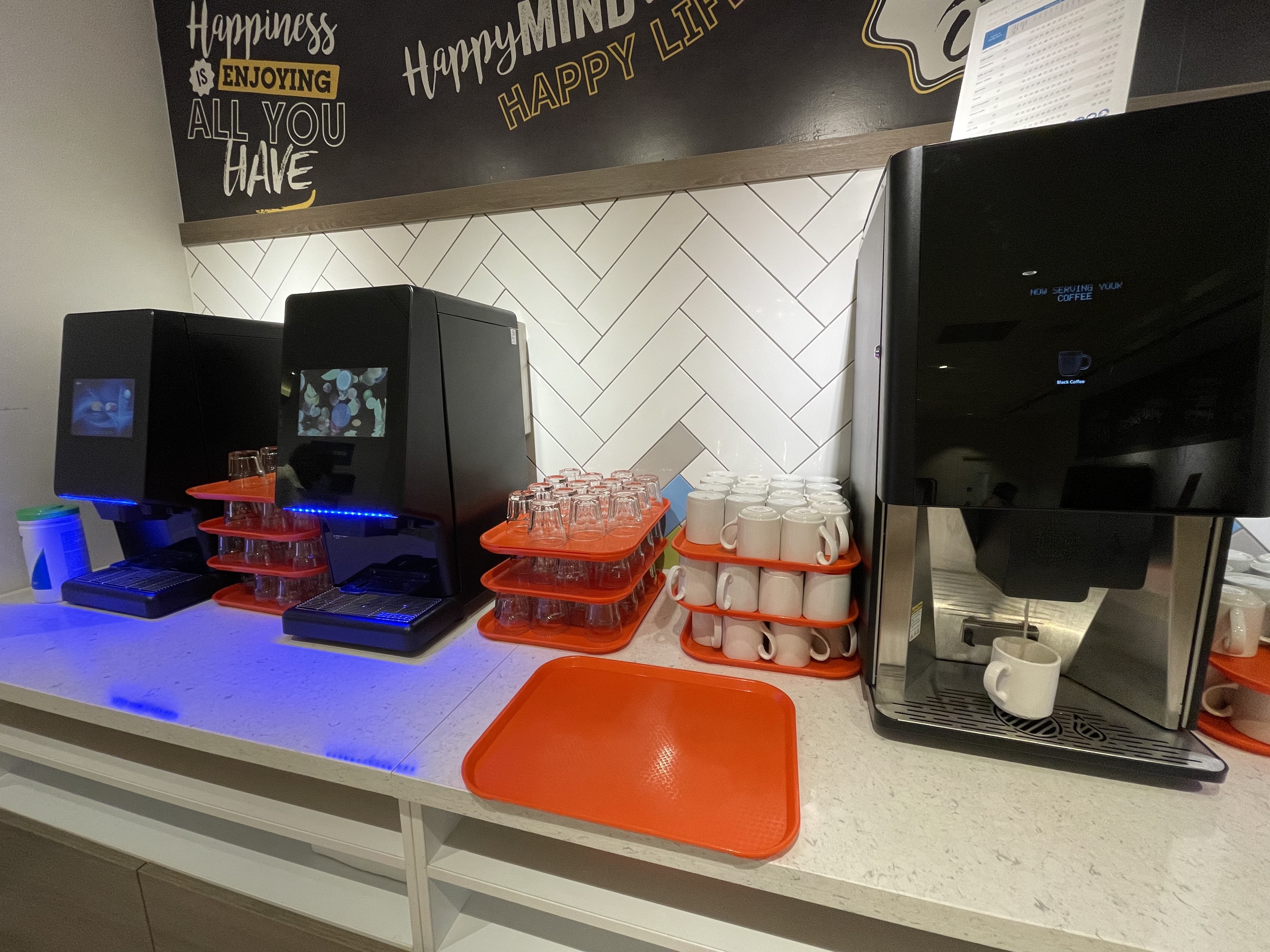 a coffee machine and cups on a counter