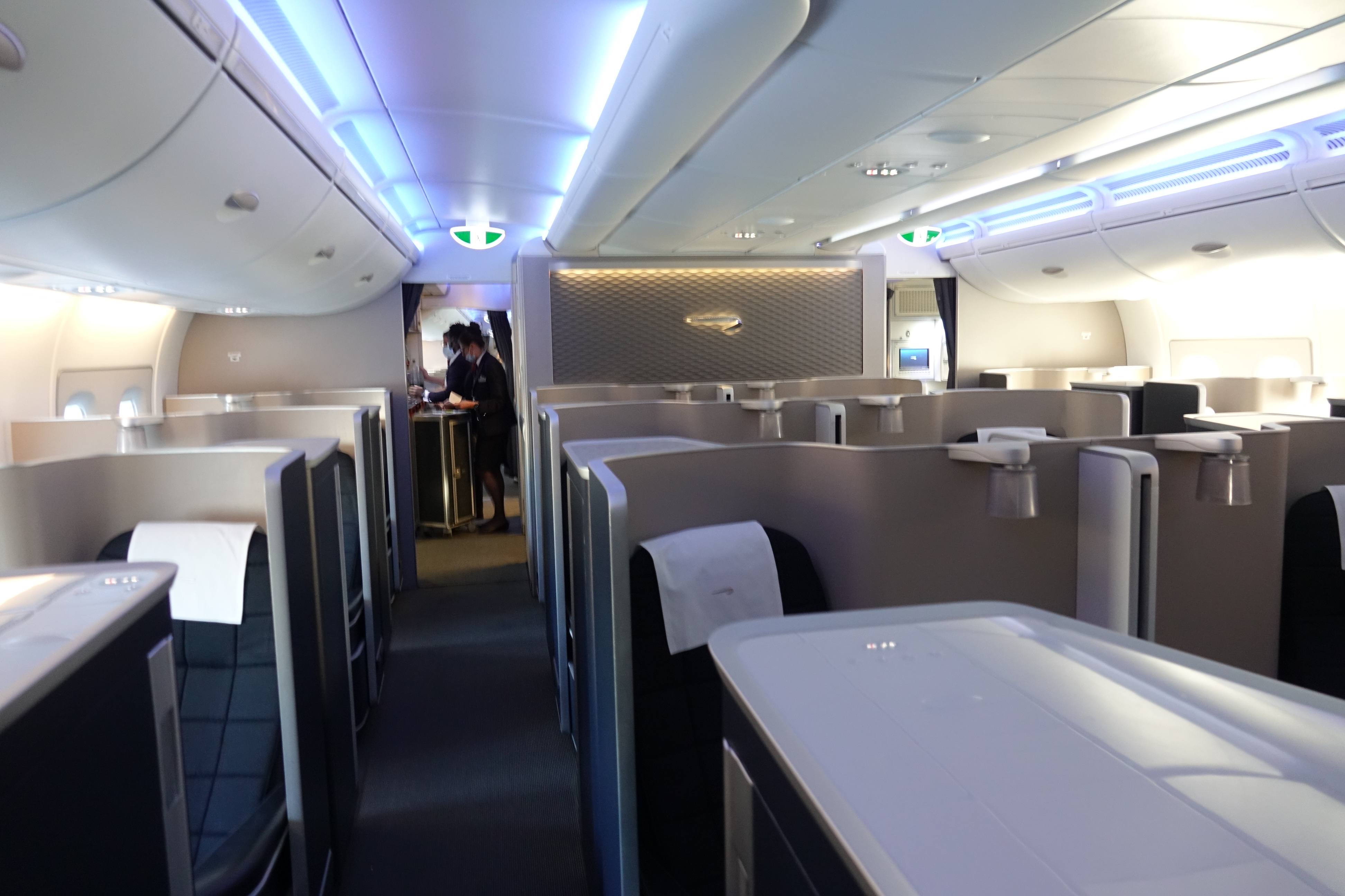 a inside of an airplane with a man standing behind the counter