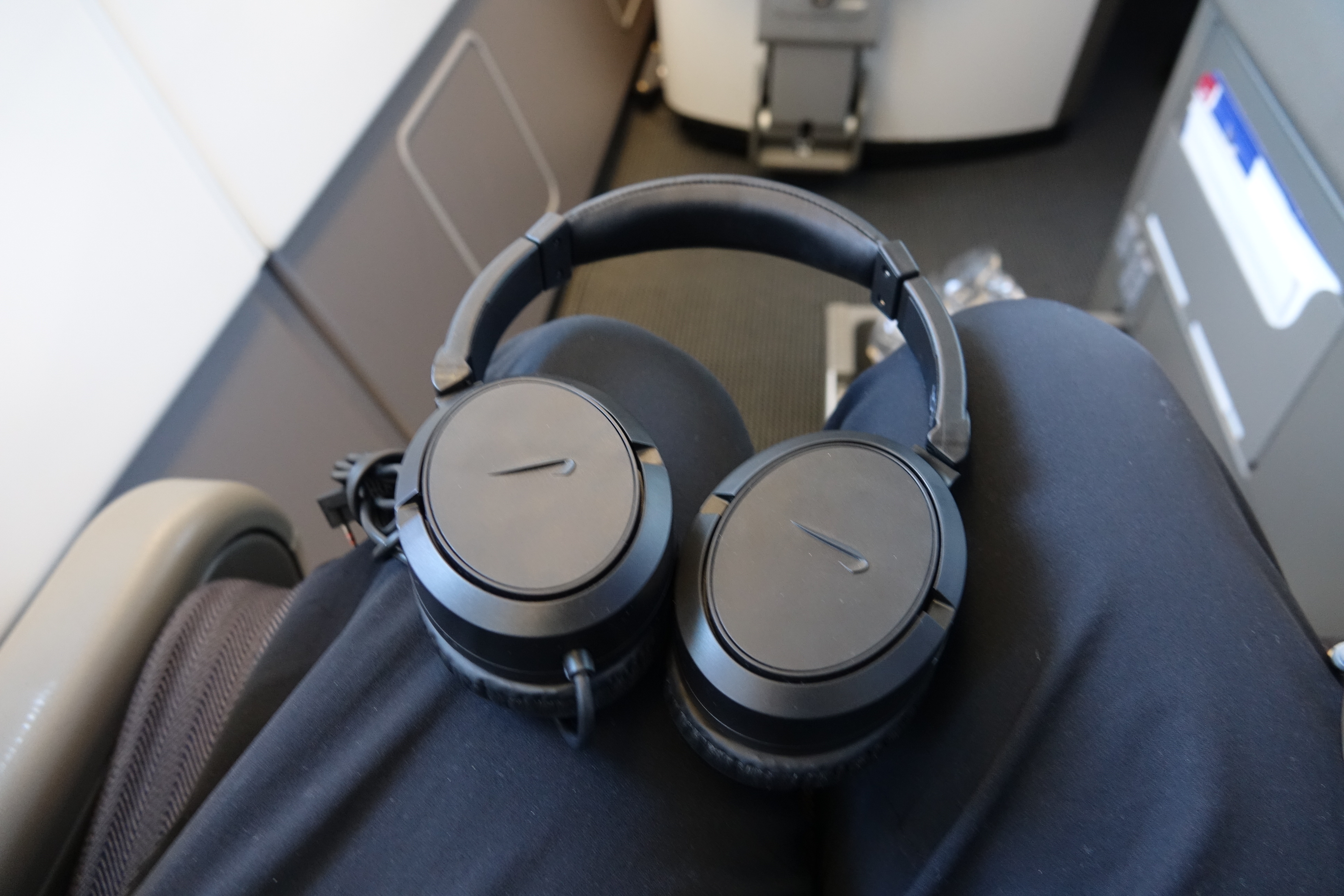 a pair of black headphones on a person's lap