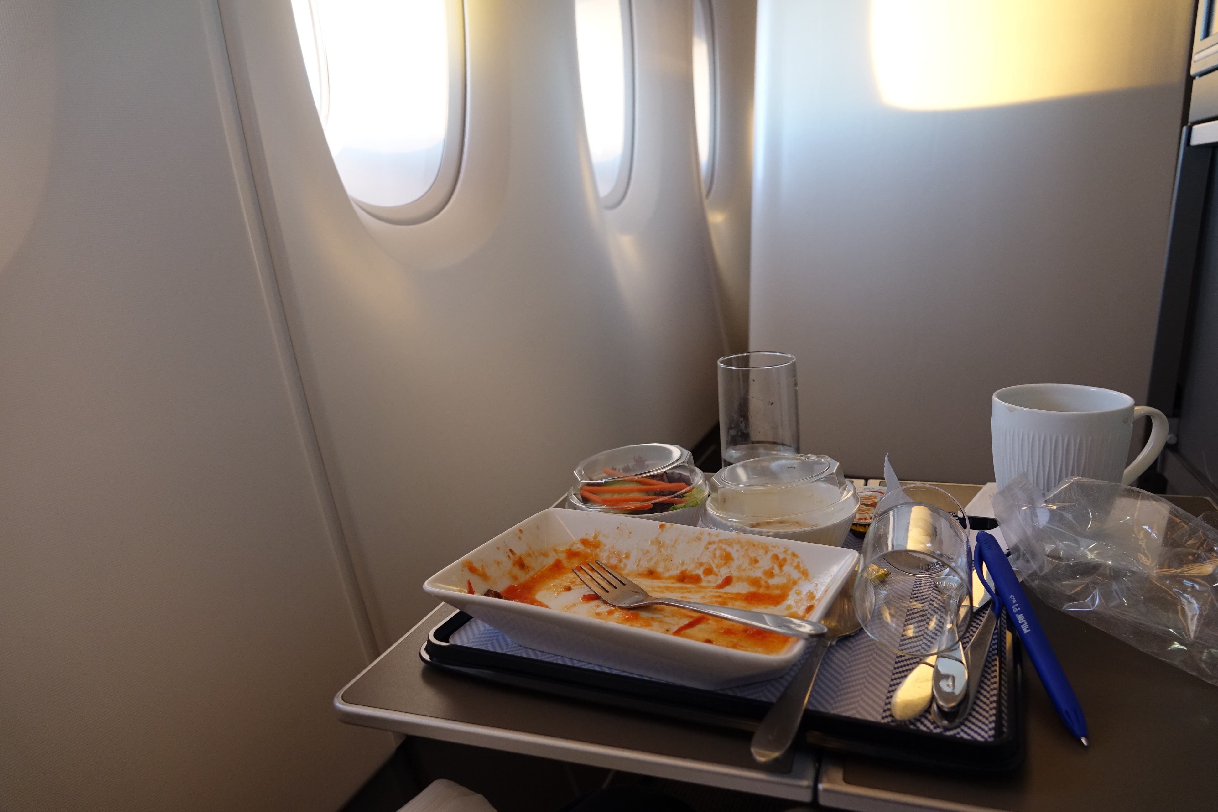 a tray with food on it and a fork on the table