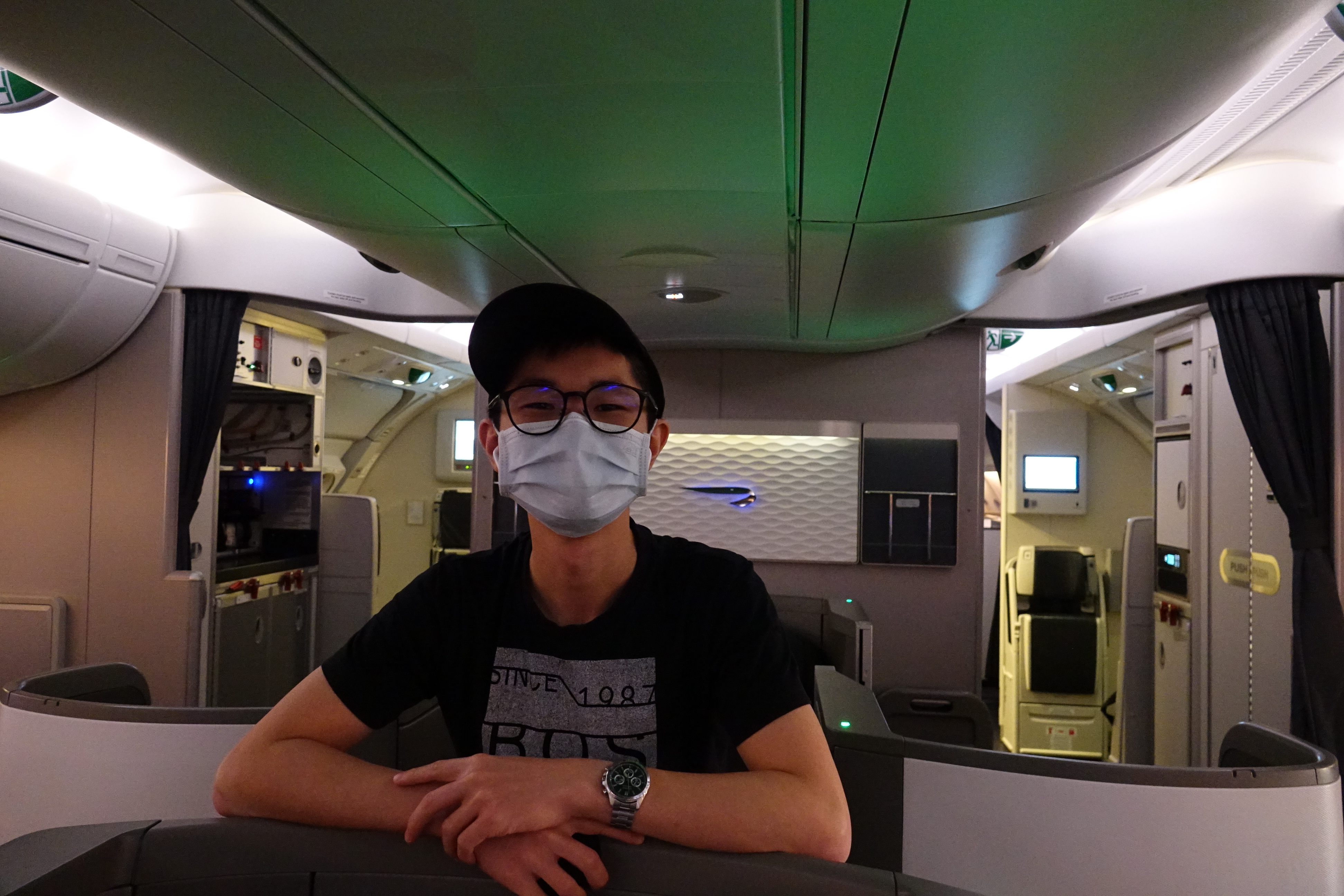 a man wearing a mask on an airplane