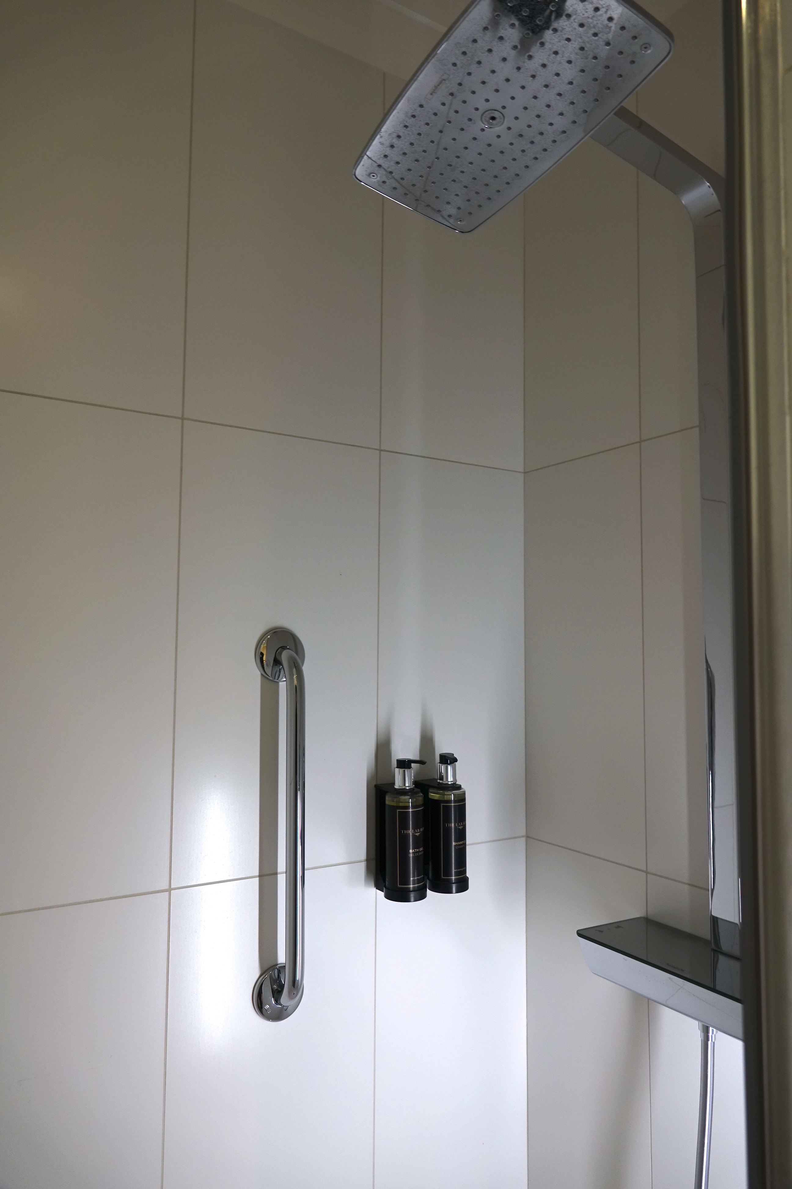 a shower with a shower head and shower head