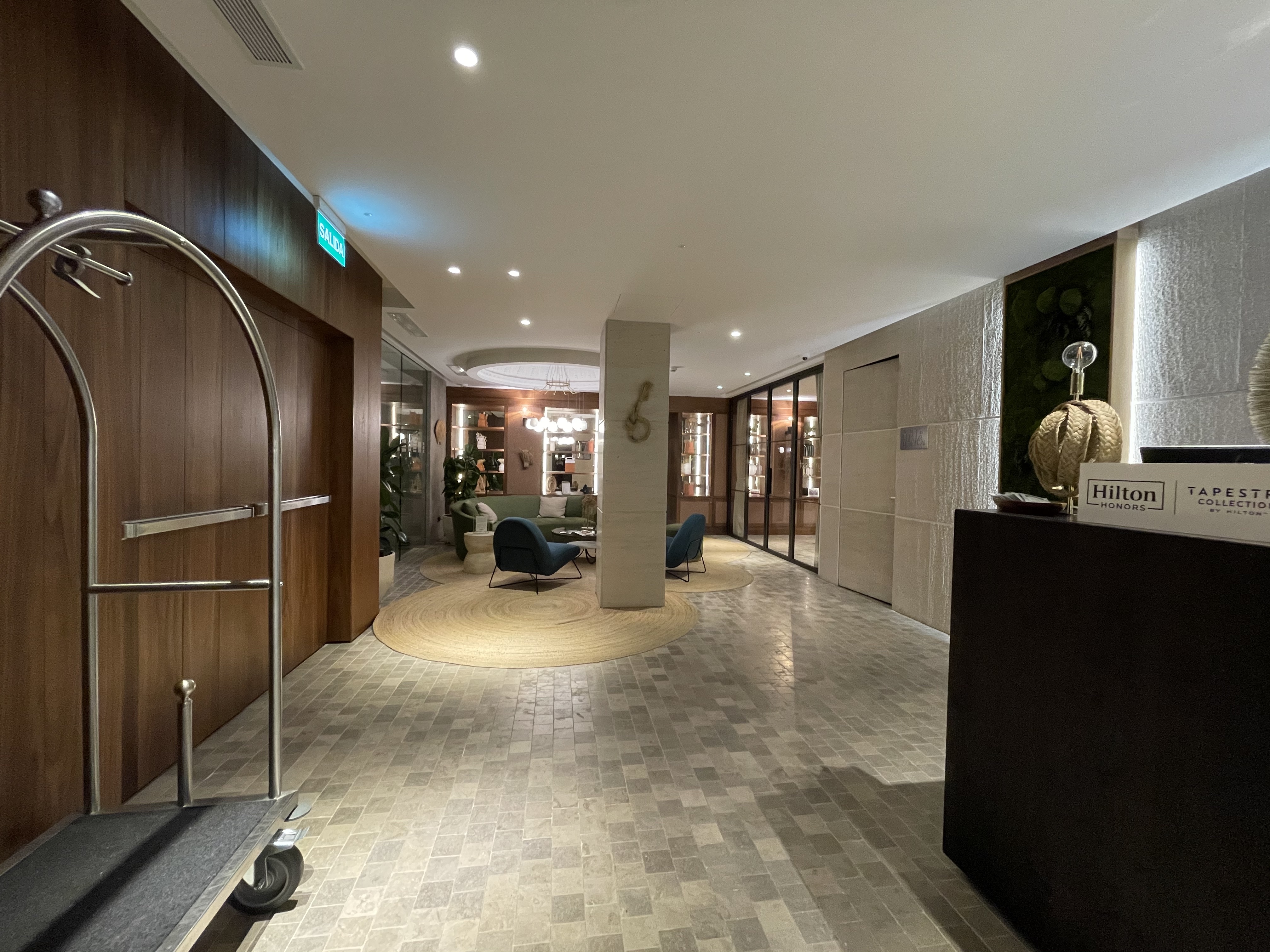 a lobby with a large round table and a blue chair