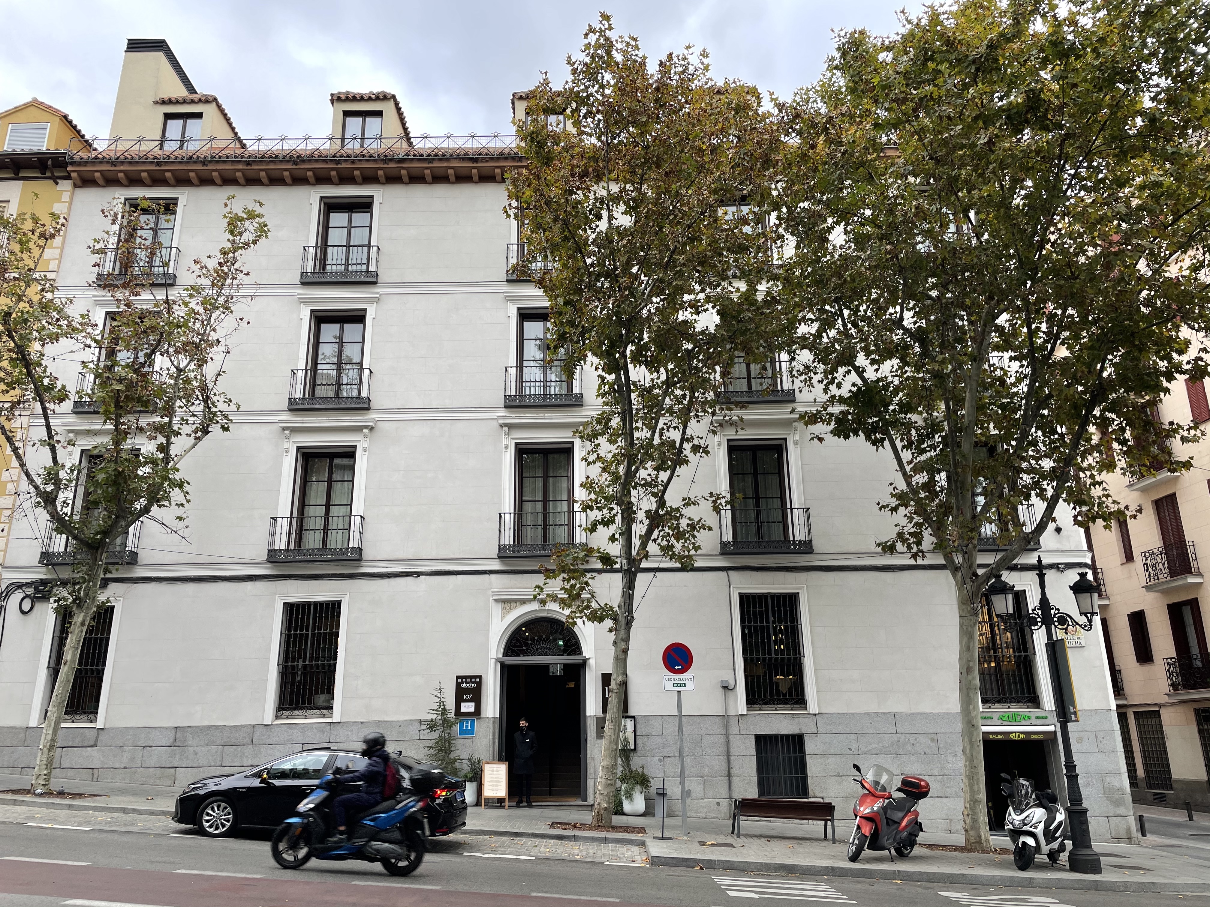 a building with trees and motorcycles