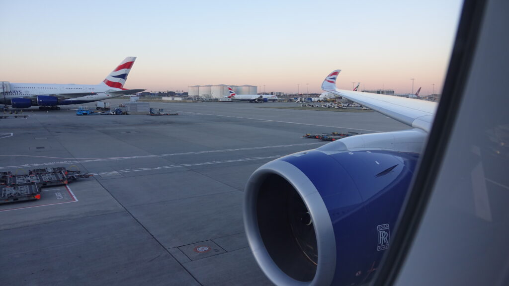 an airplane wing and engine on a runway