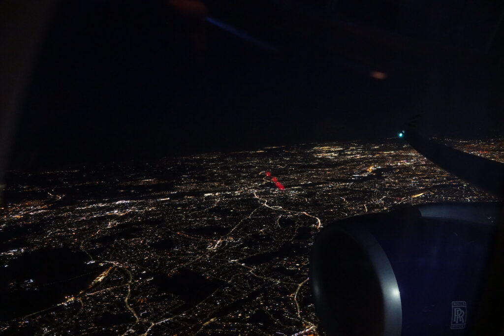 an airplane wing and a city at night