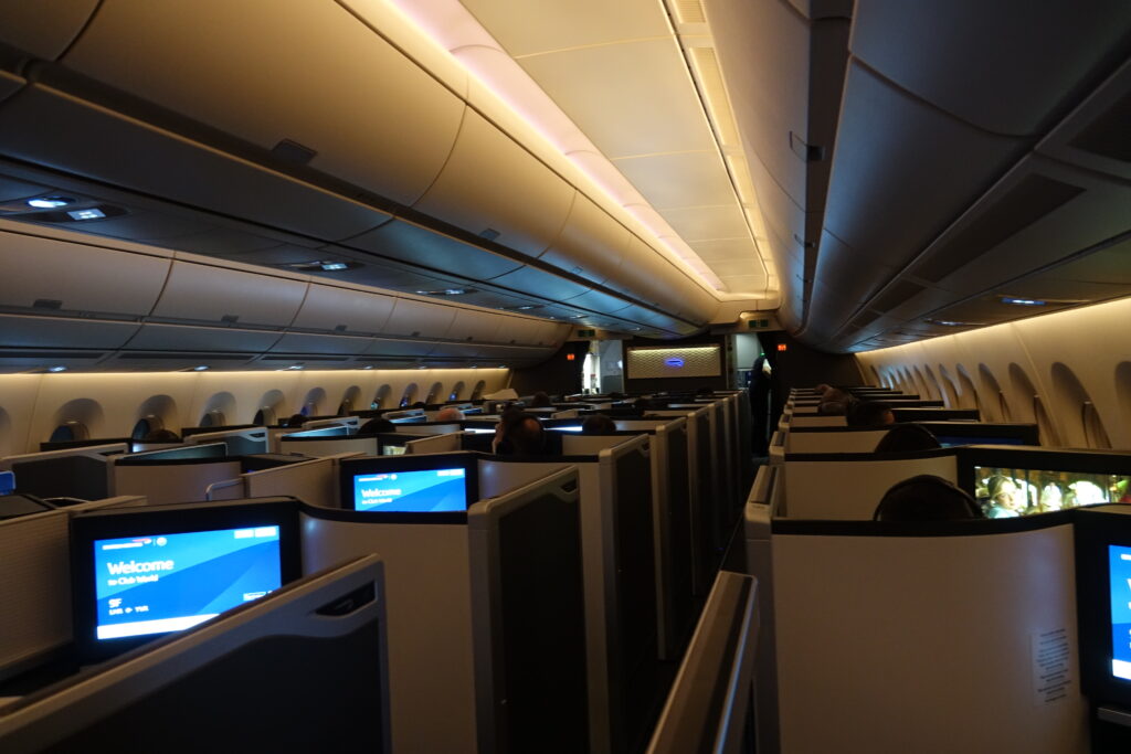 an airplane with a few people sitting in the seats