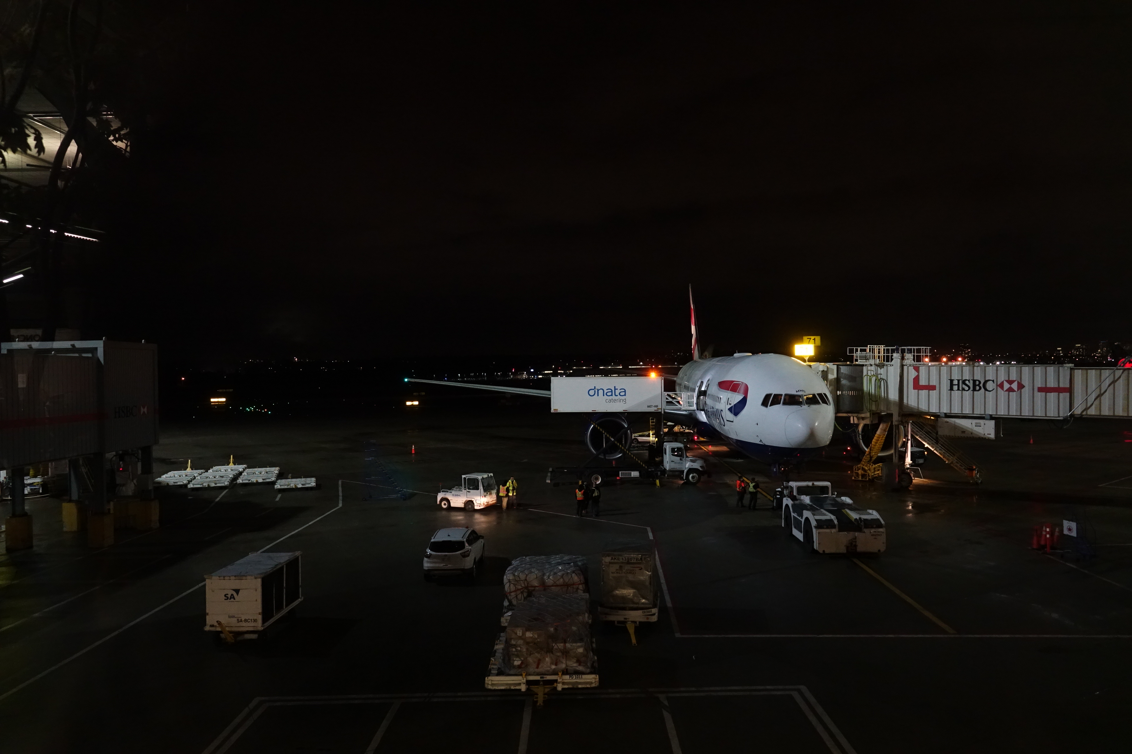 an airplane at night with cars and trucks