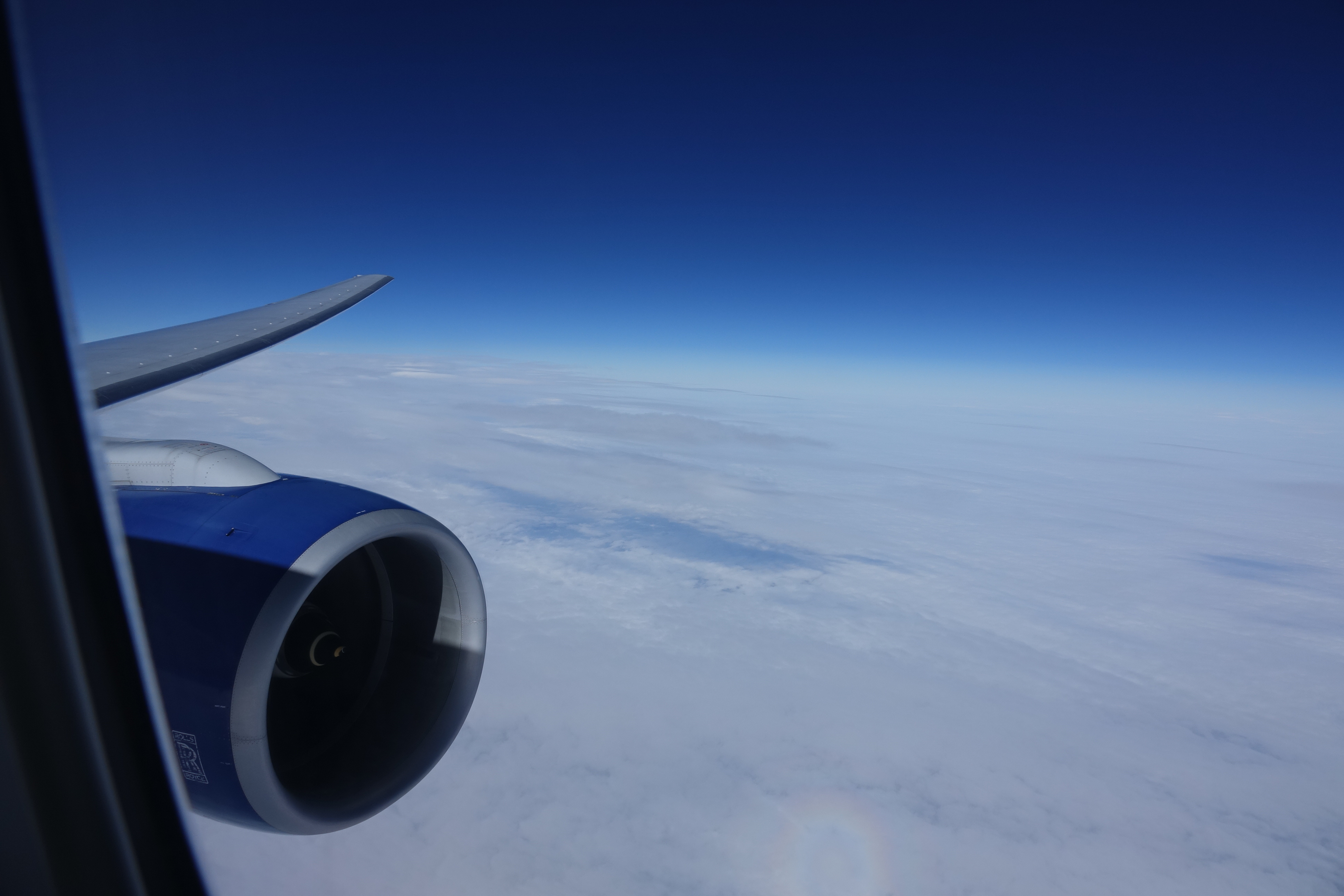 an airplane wing and a blue sky