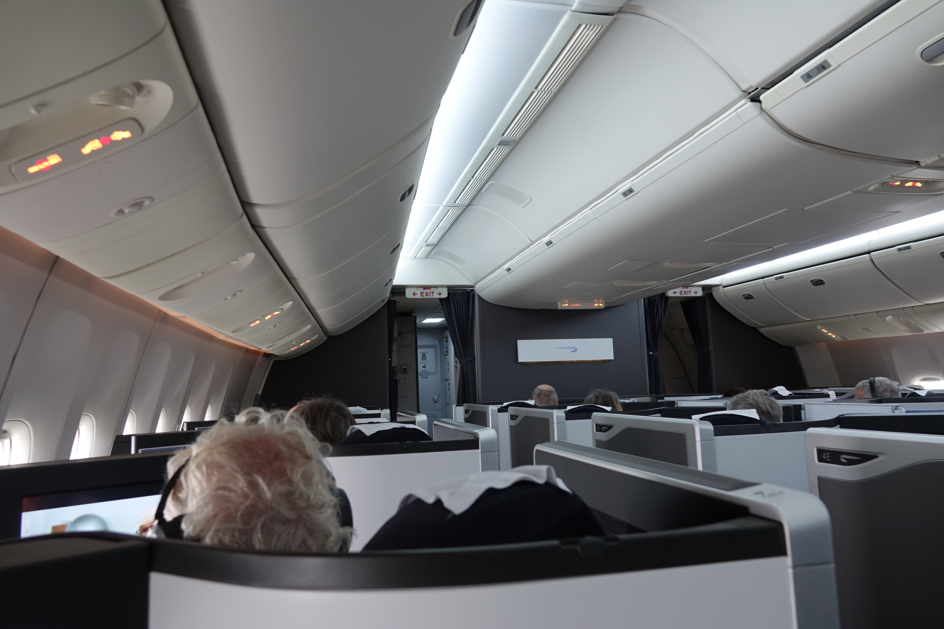 a group of people sitting in chairs on an airplane