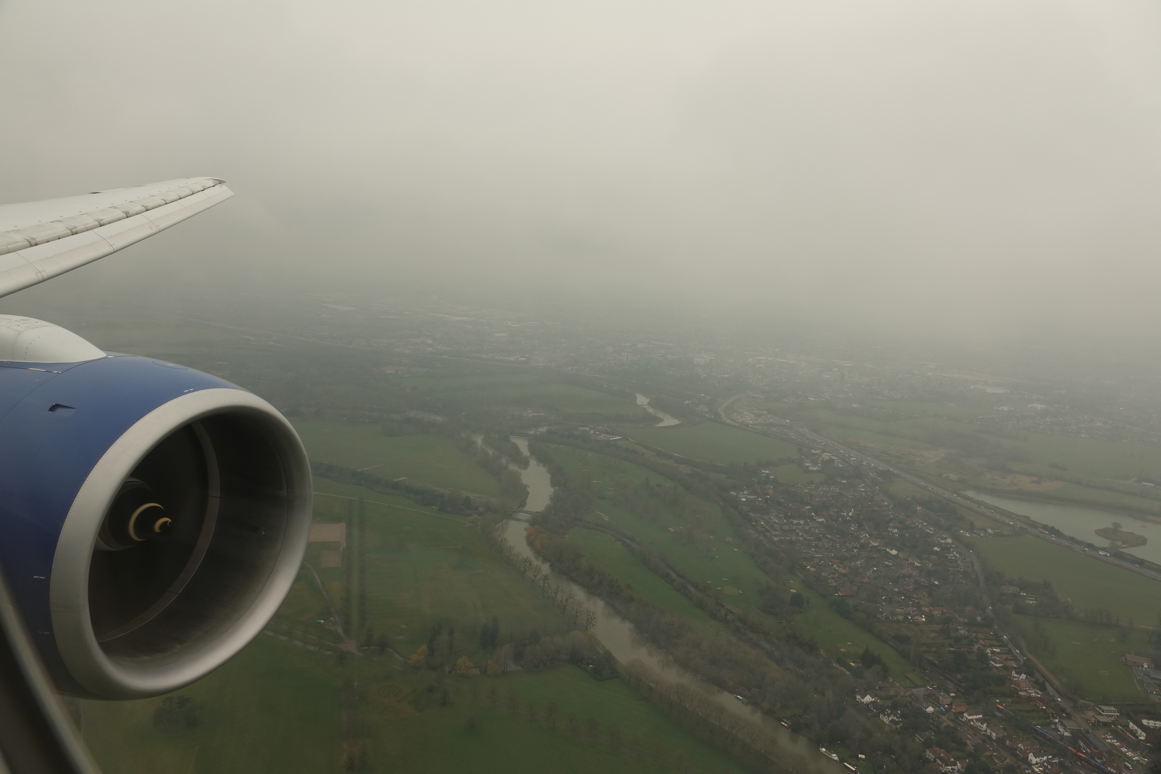 an airplane wing and a river in the sky