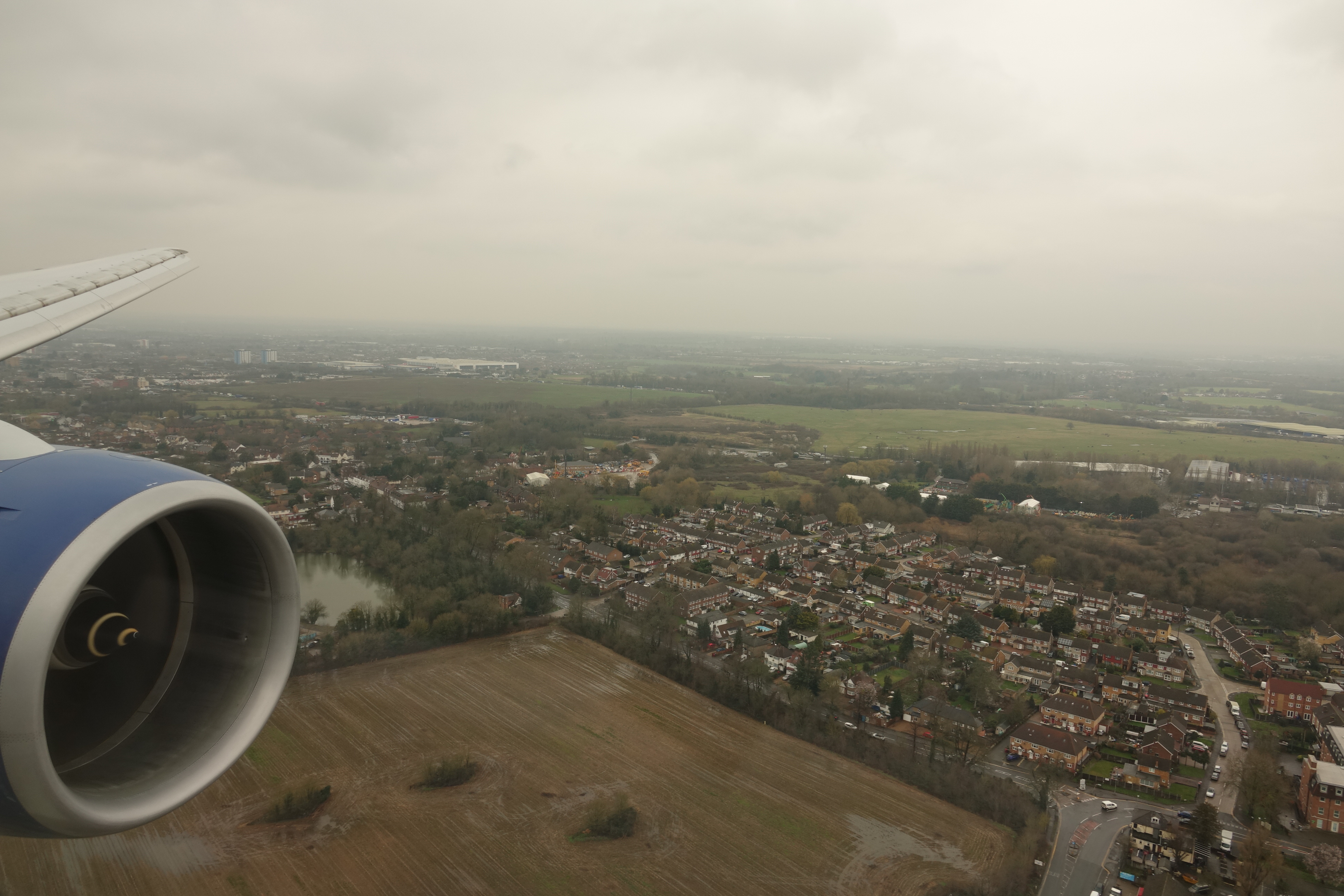 an airplane wing and a city