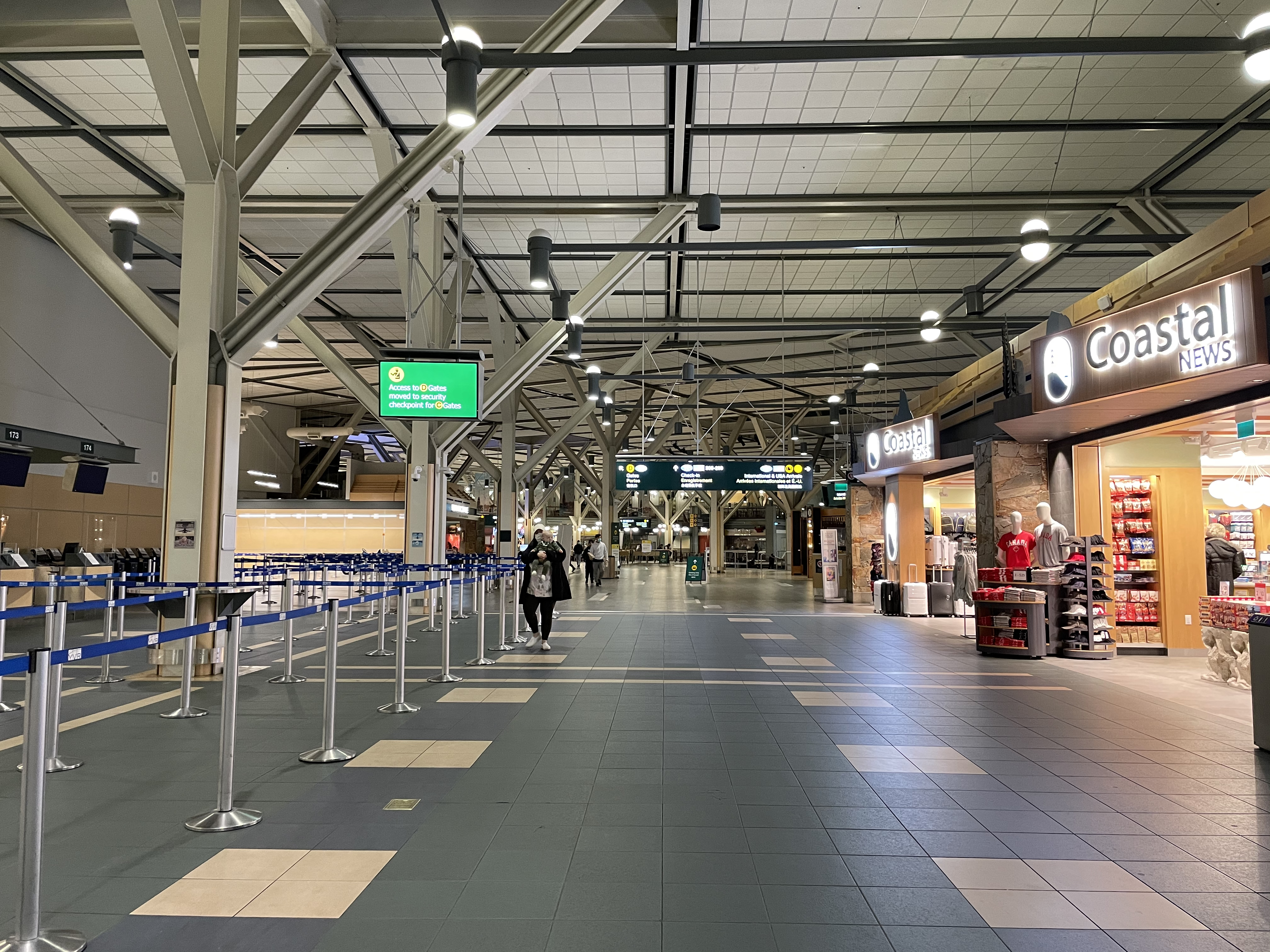 a large airport terminal with people walking