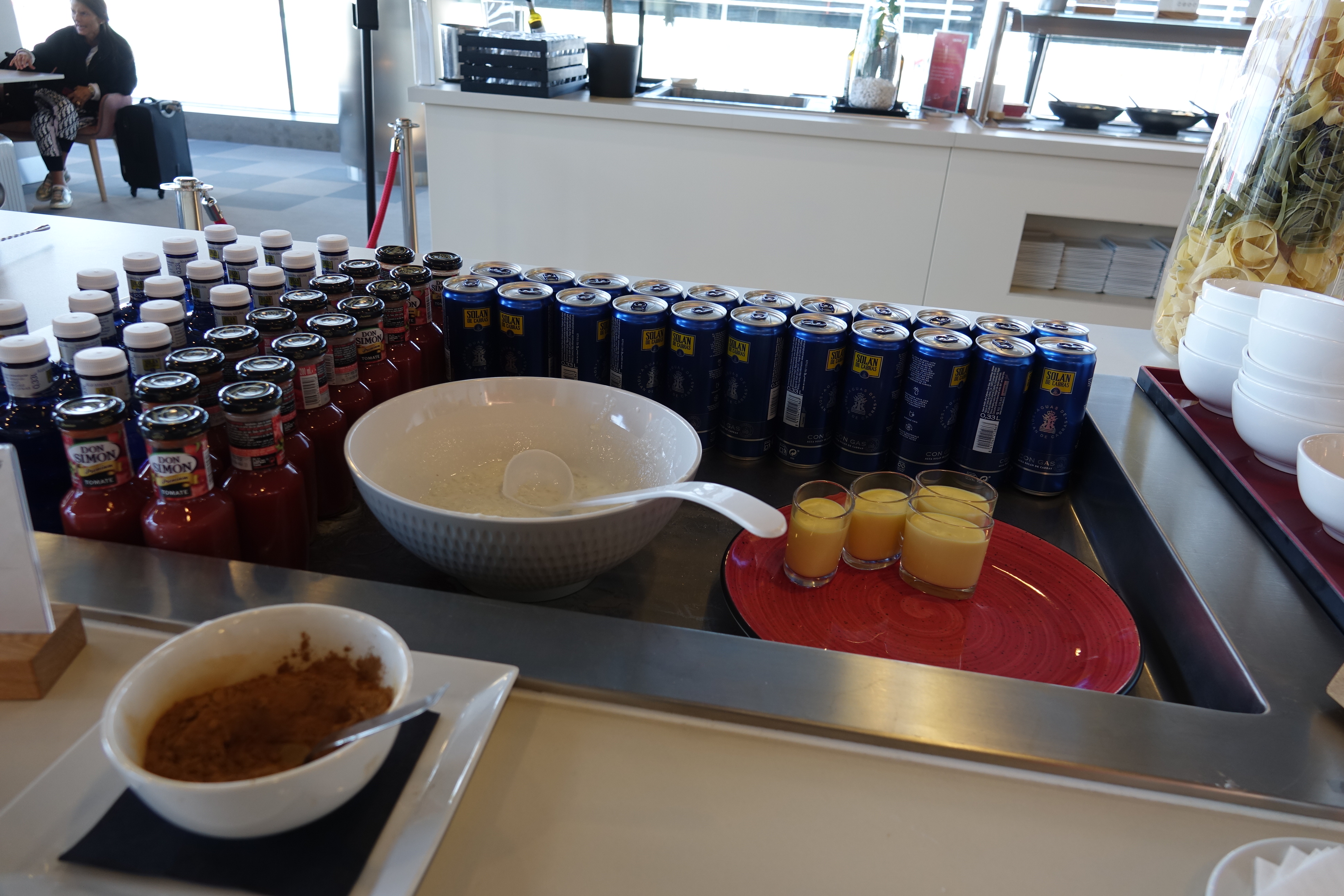 a table with drinks and a bowl of food