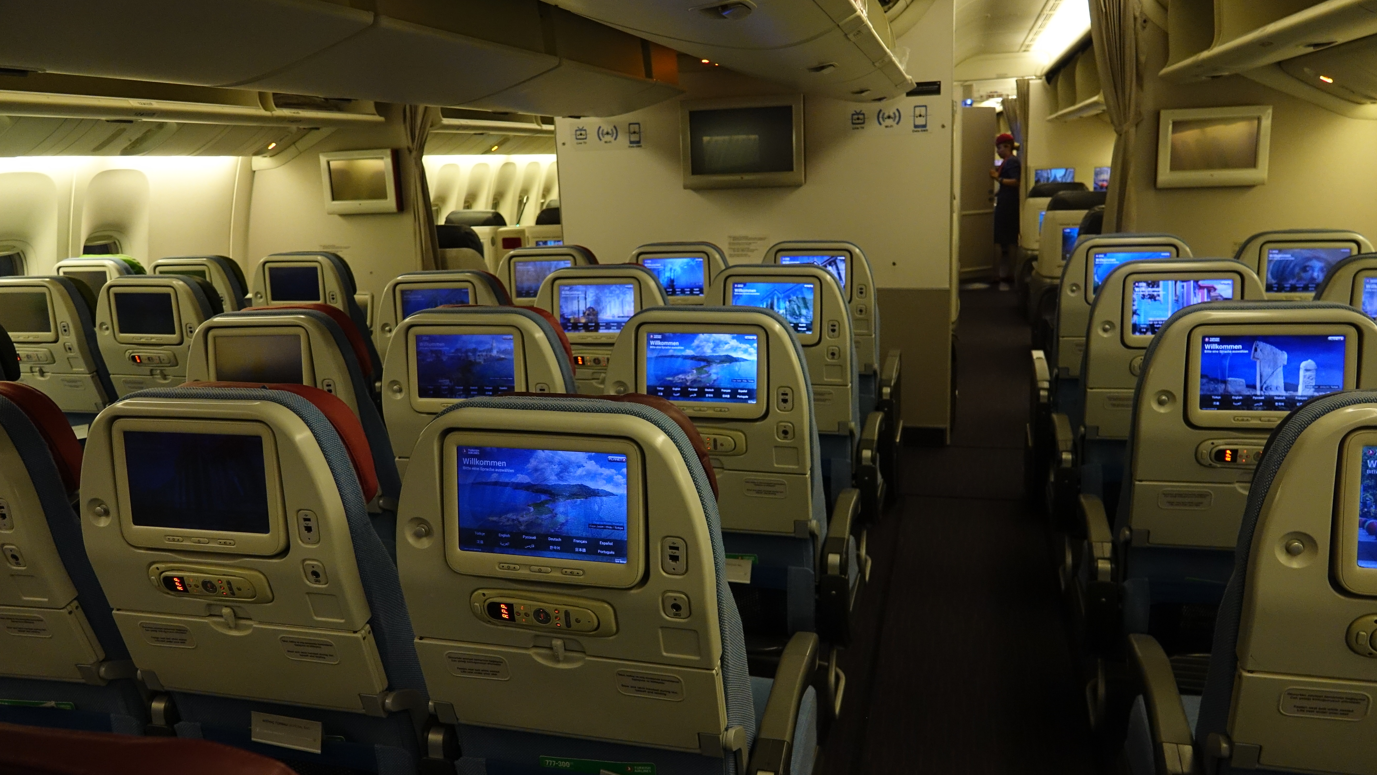 a row of seats with monitors on the back