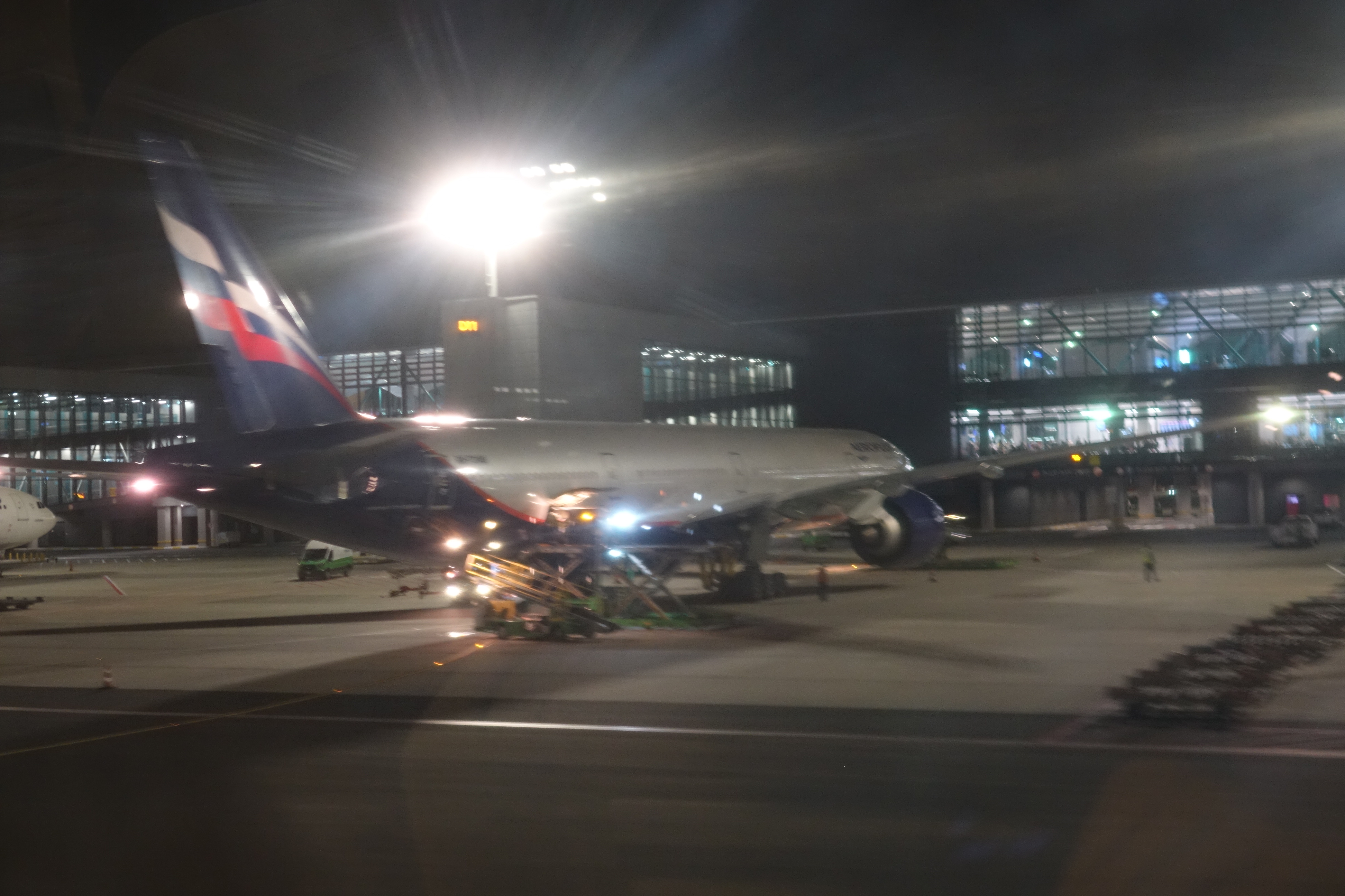 an airplane on the tarmac at night