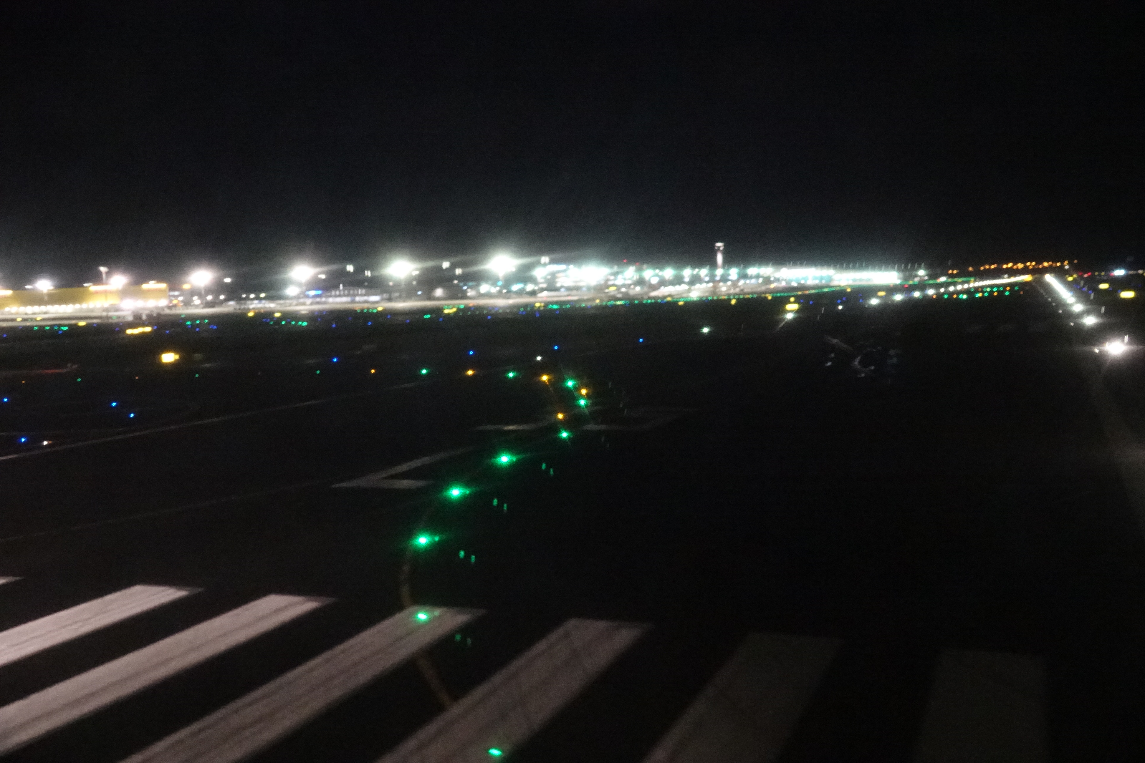 a runway at night with lights on