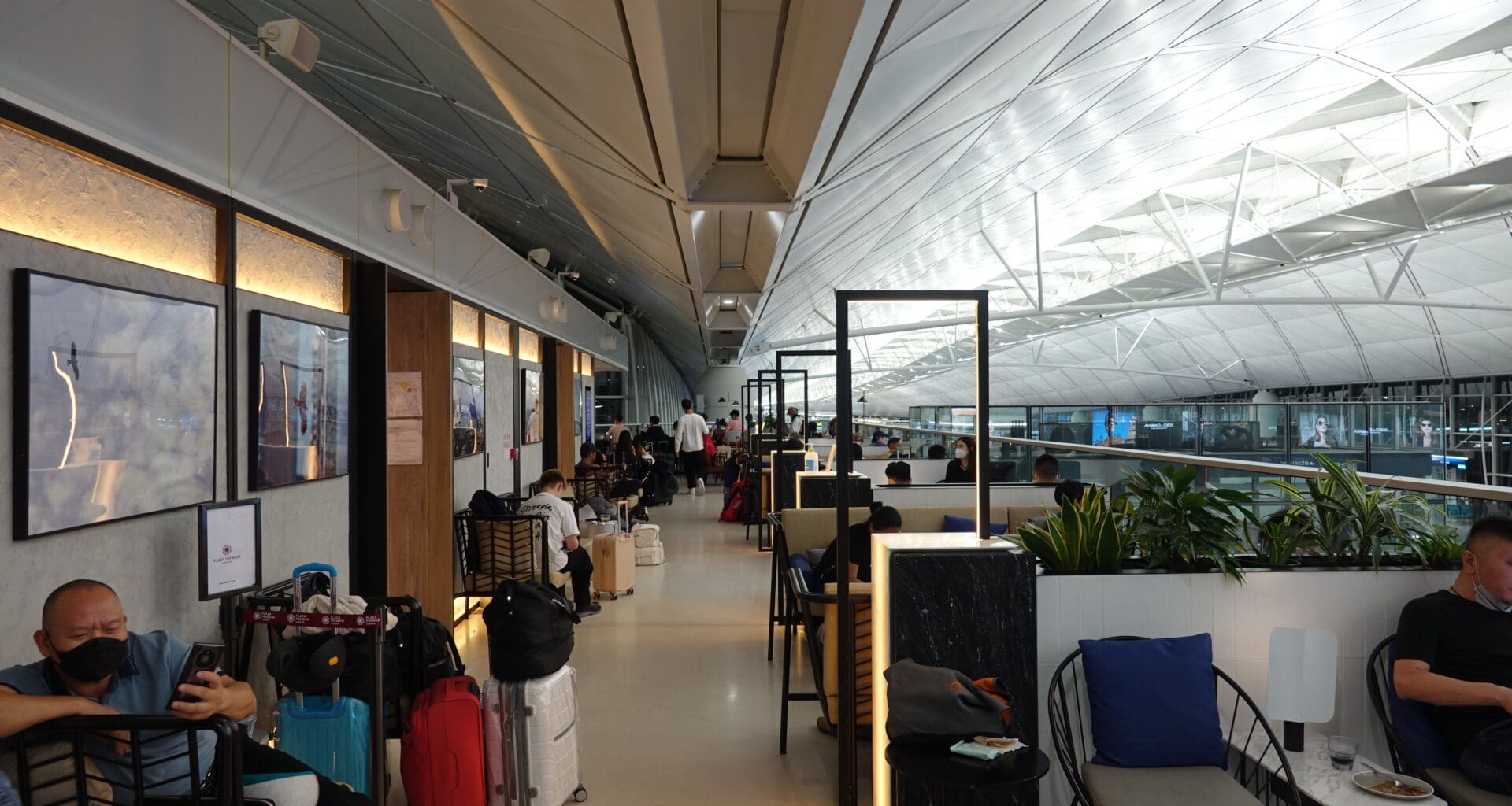 a group of people sitting in a room with chairs and tables