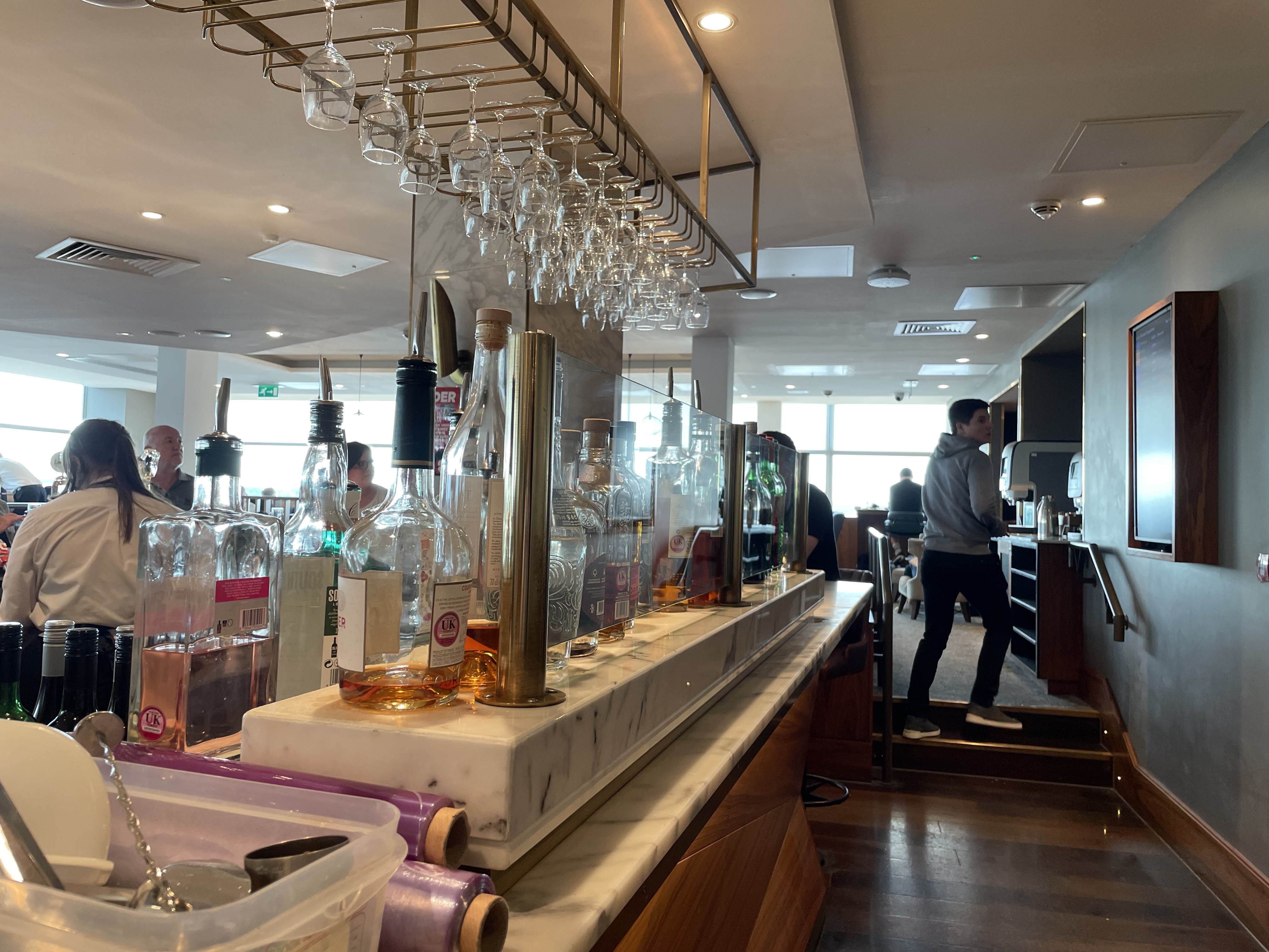 a bar with wine glasses from a rack