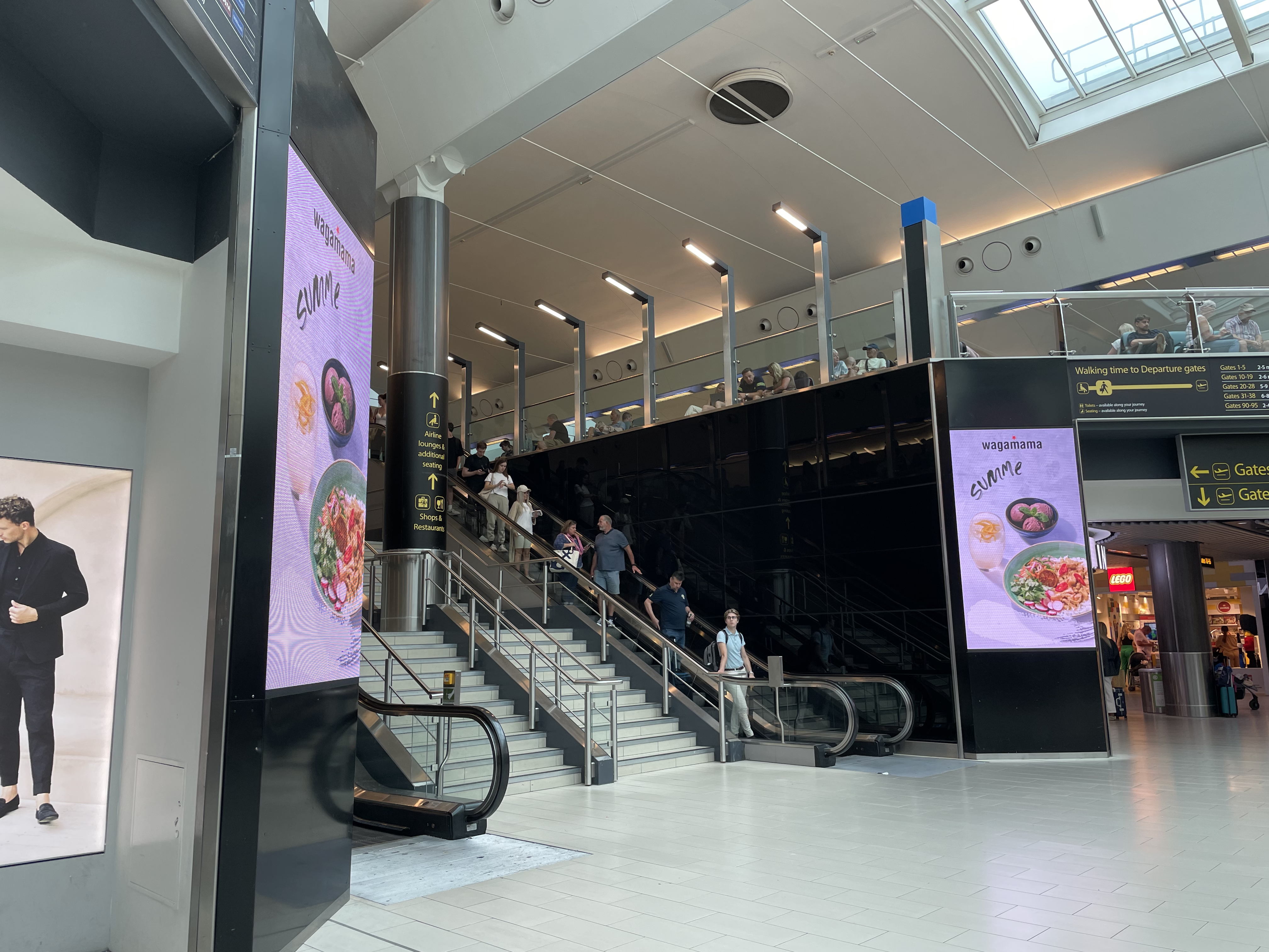 people on escalators in a building