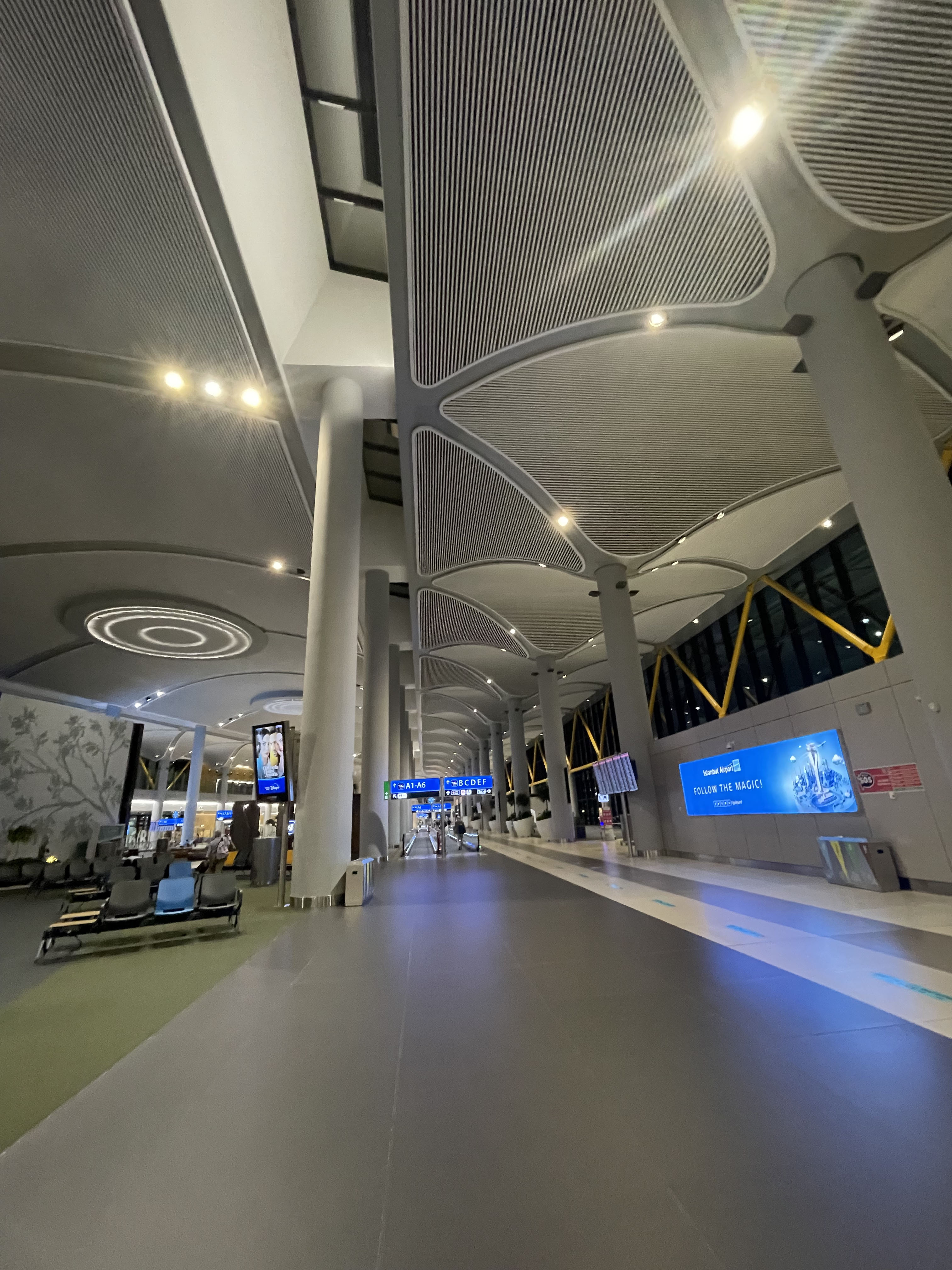 a large airport terminal with many people waiting