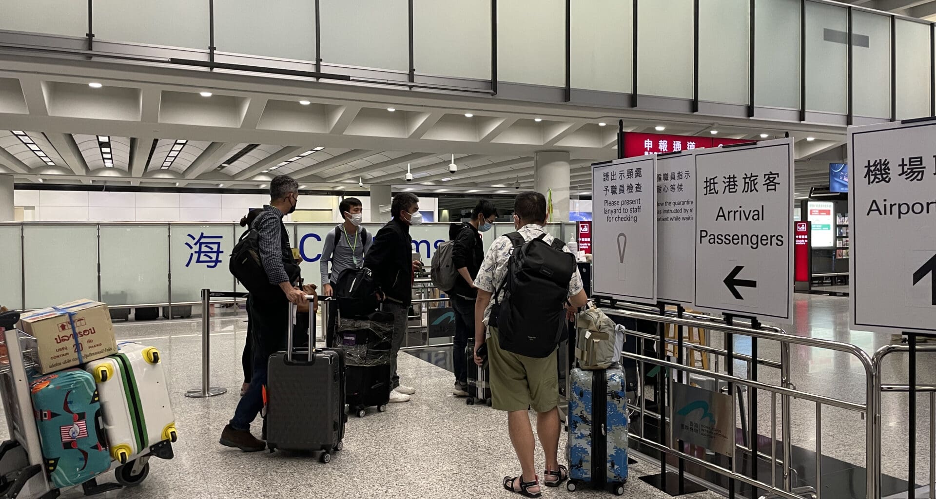 a group of people with luggage in an airport