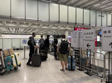 a group of people with luggage in an airport