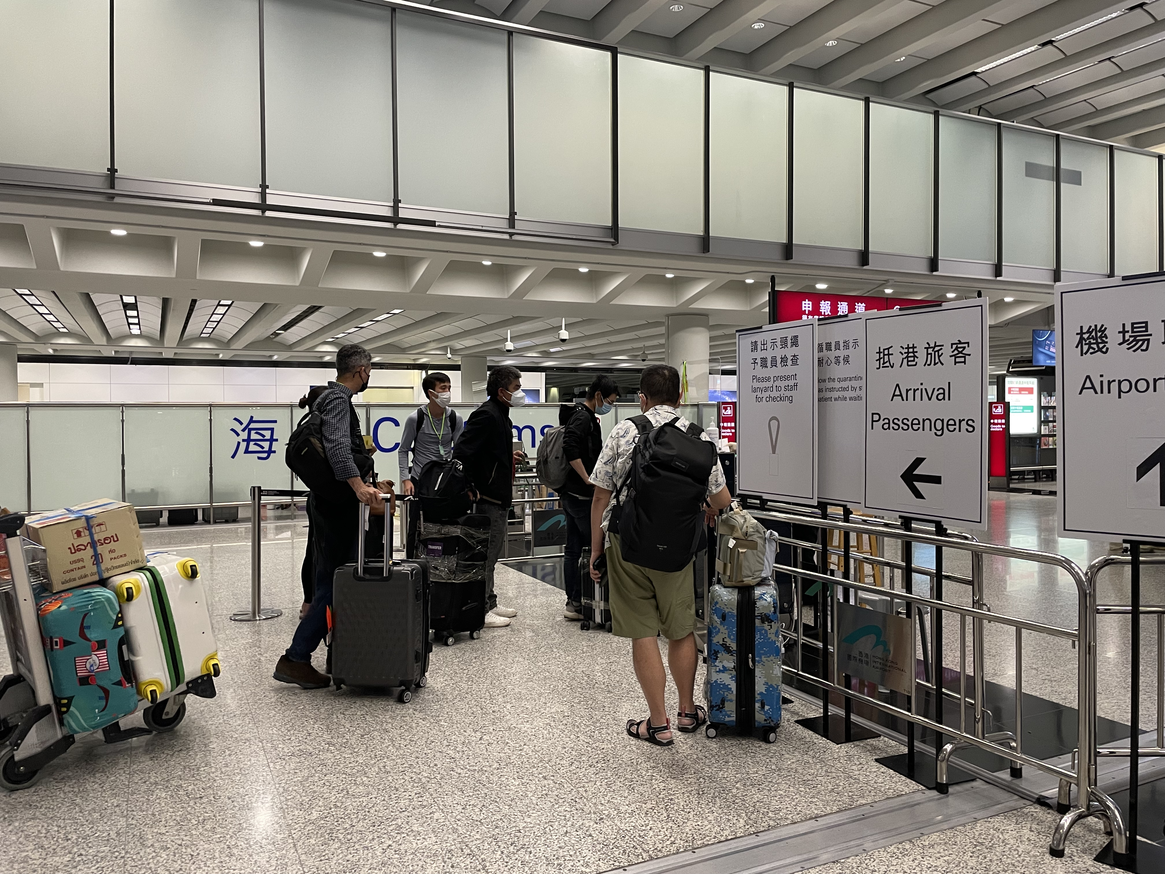 a group of people with luggage in an airport