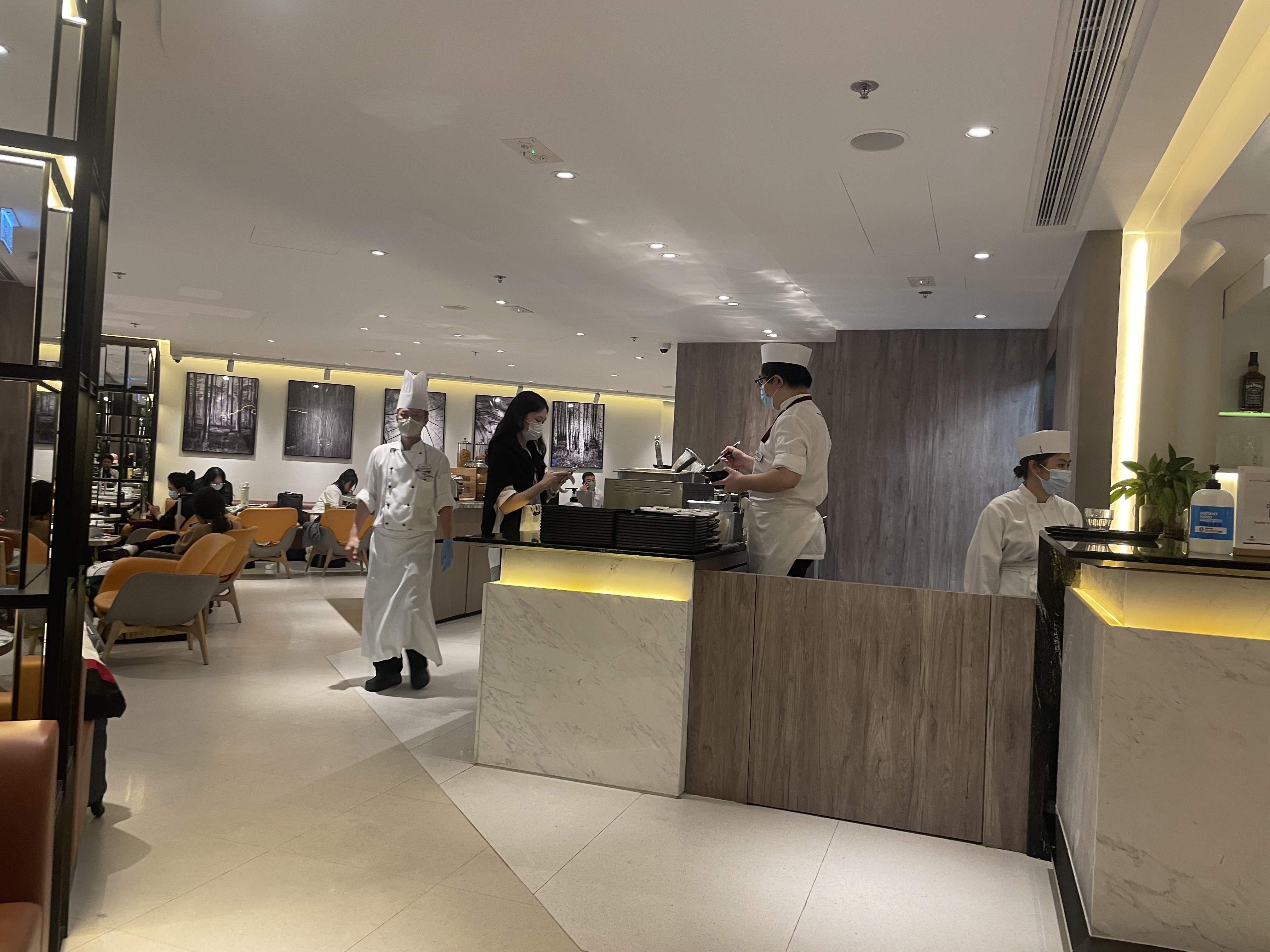 a group of people in white uniforms in a restaurant