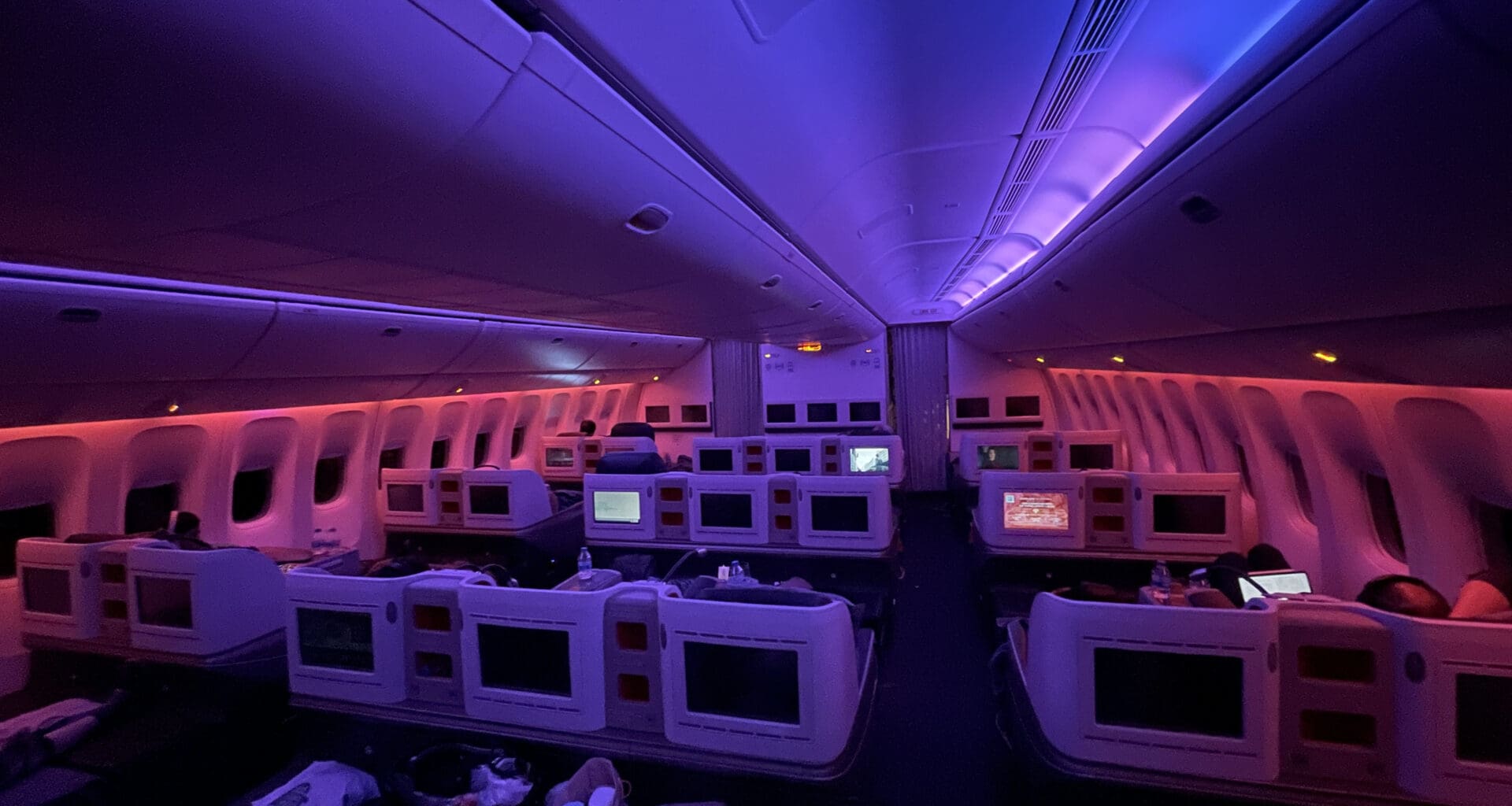 a room with rows of monitors and seats